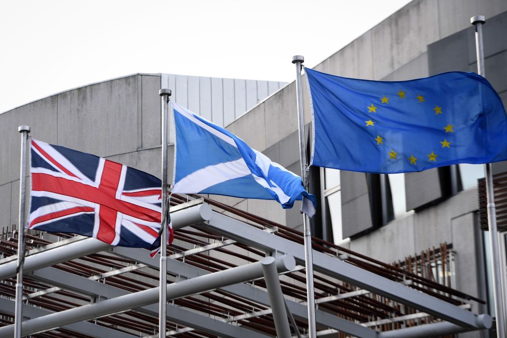 The Union Flag, Saltire of Scotland and E.U. flag fly outside the entrance to the Scottish Parliament building in Edinburgh on Jan. 29, 2020. (Andy Buchanan—AFP/Getty Images)