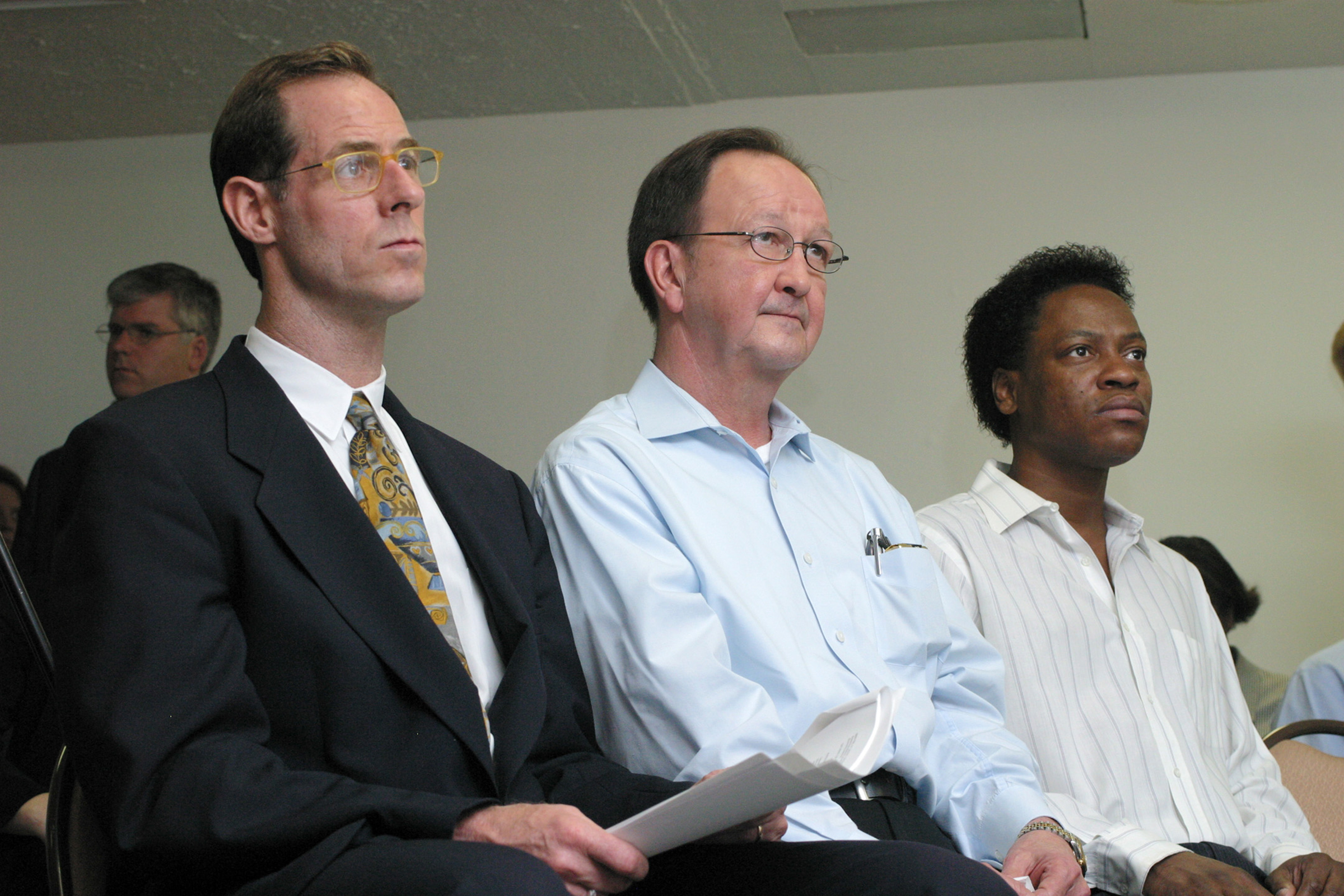 The two men who spent the night in jail in 1998 on sodomy charges, John Lawrence, center, and Tyron Garner, right, sit with their attorney Lee Taft, left, during a press conference in Houston on June 26, 2003. (Michael Stravato—AP)