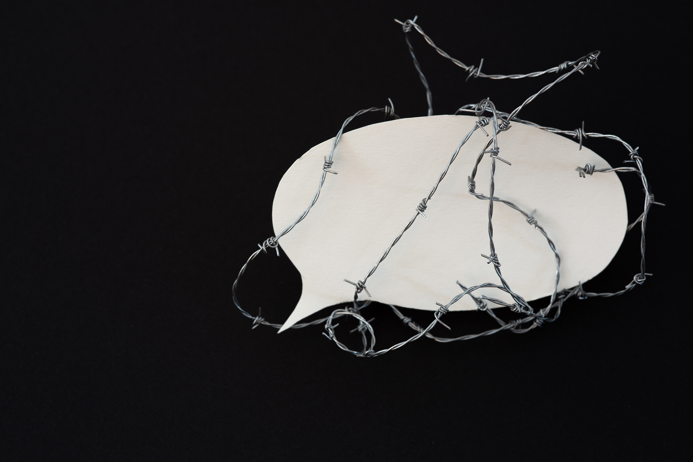 Protect the freedom of speech - barbed wire around a speech bubble