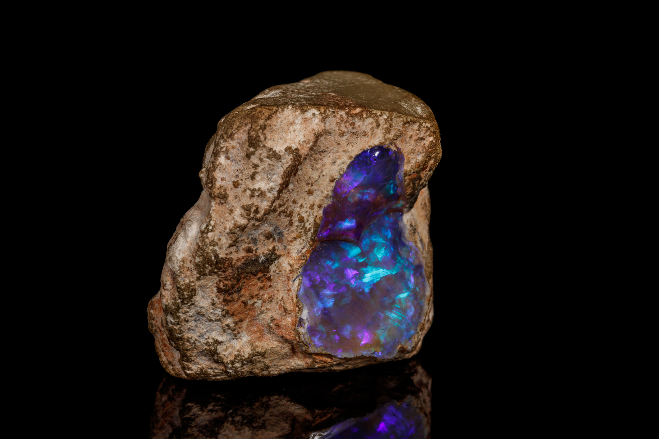 Macro stone Opal mineral in rock on a black background