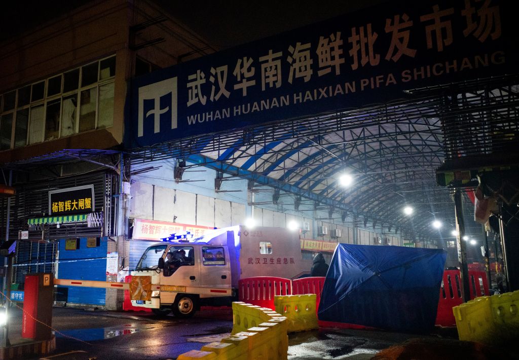 Members of staff of the Wuhan Hygiene Emergency Response Team drive their vehicle as they leave the closed Huanan Seafood Wholesale Market in the city of Wuhan, in Hubei, Province on January 11, 2020, where the Wuhan health commission said that the man who died from a respiratory illness had purchased goods. (Noel Celis–AFP/Getty)