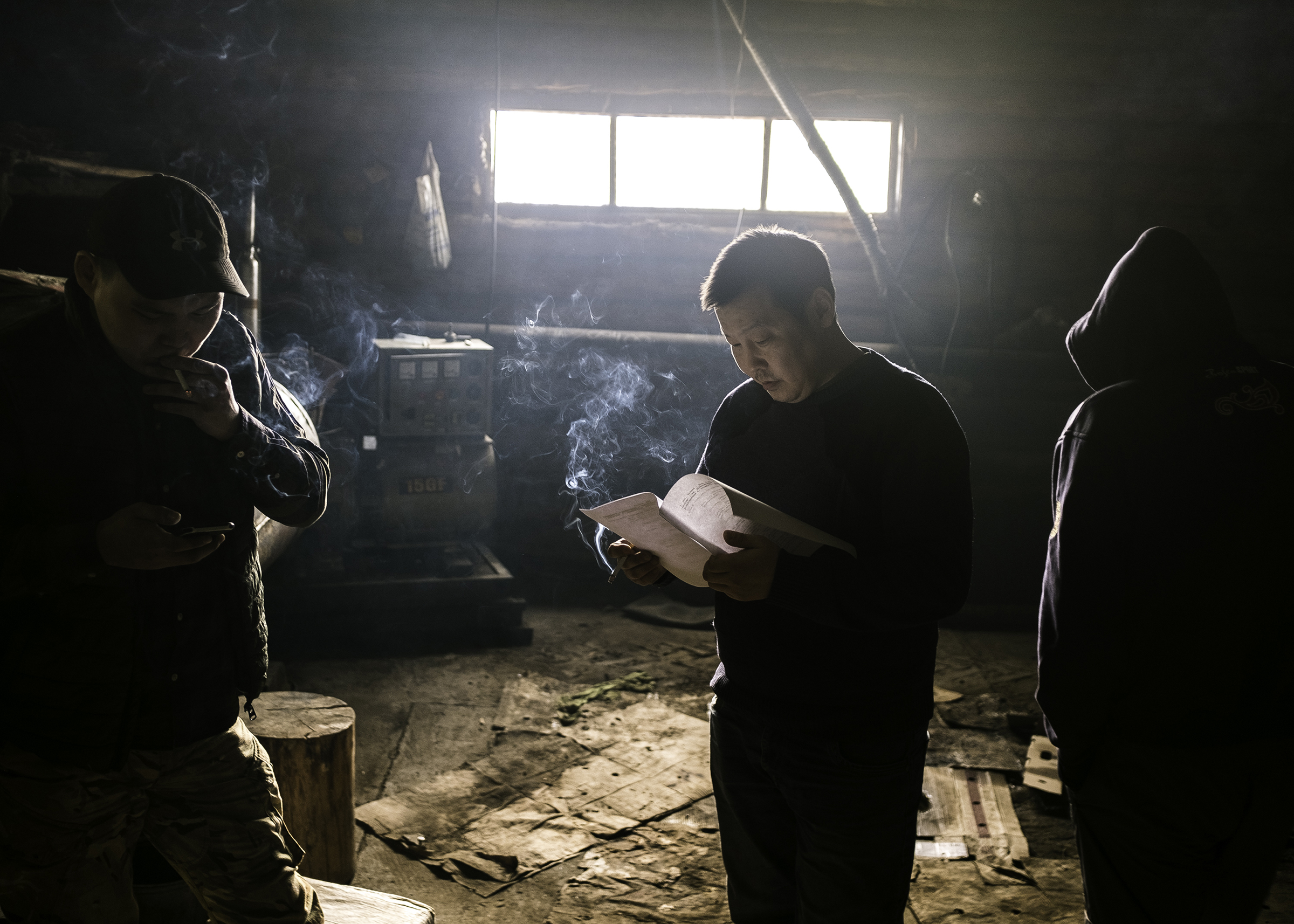 Actors playing the role of truckers in the drama "Khara Khaar" (Black Snow) rehearse their parts in the smoking room of a roadside cafe, where the scene takes place. (Alexey Vasilyev)