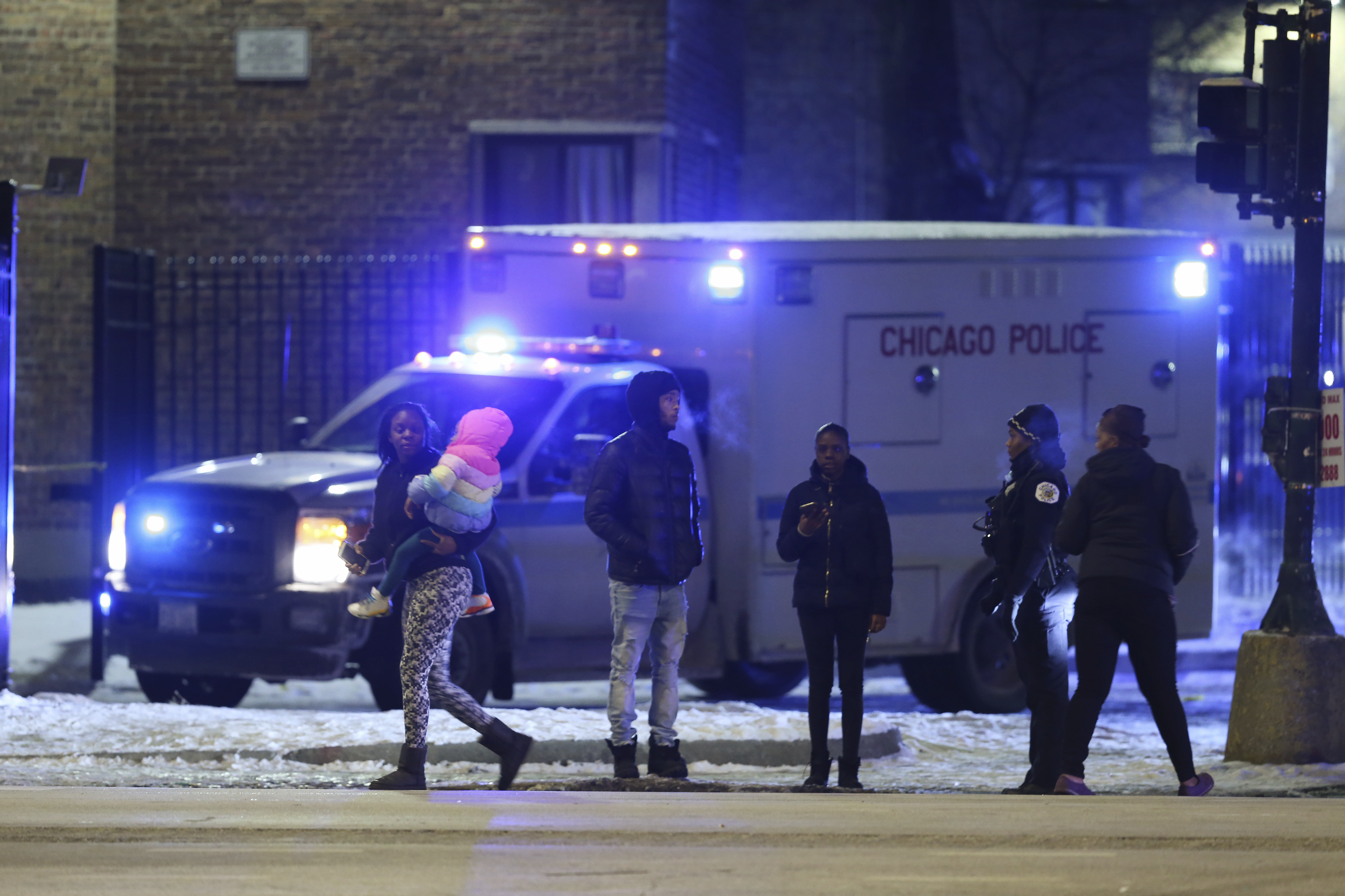 Emergency responders work the scene of a shooting on Feb. 14, 2020 in Chicago. Six people were wounded in the shooting at an apartment complex on Chicago's South Side, police said. (John J. Kim—AP/Chicago Tribune)