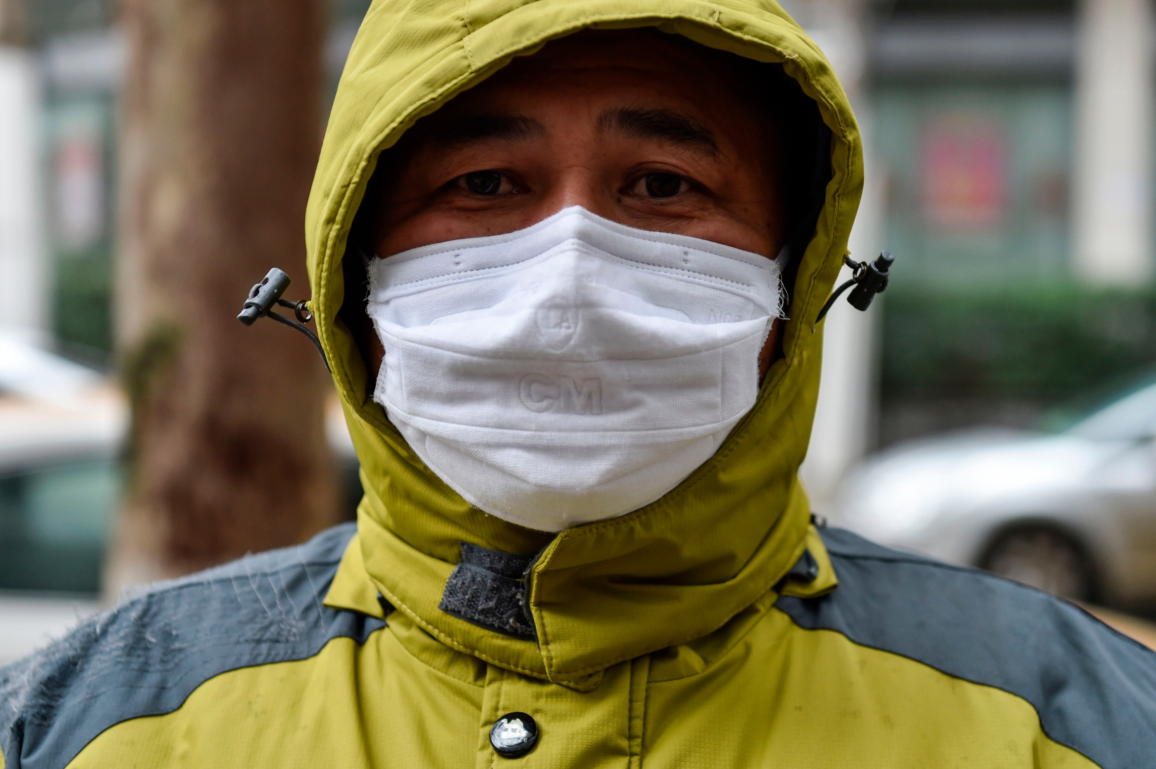 A man who works as a volunteer taking medicine for those who need it waits outside a pharmacy in Wuhan on January 26, 2020, the Chinese city at the epicenter of the coronavirus outbreak (HECTOR RETAMAL/AFP via Getty Images)
