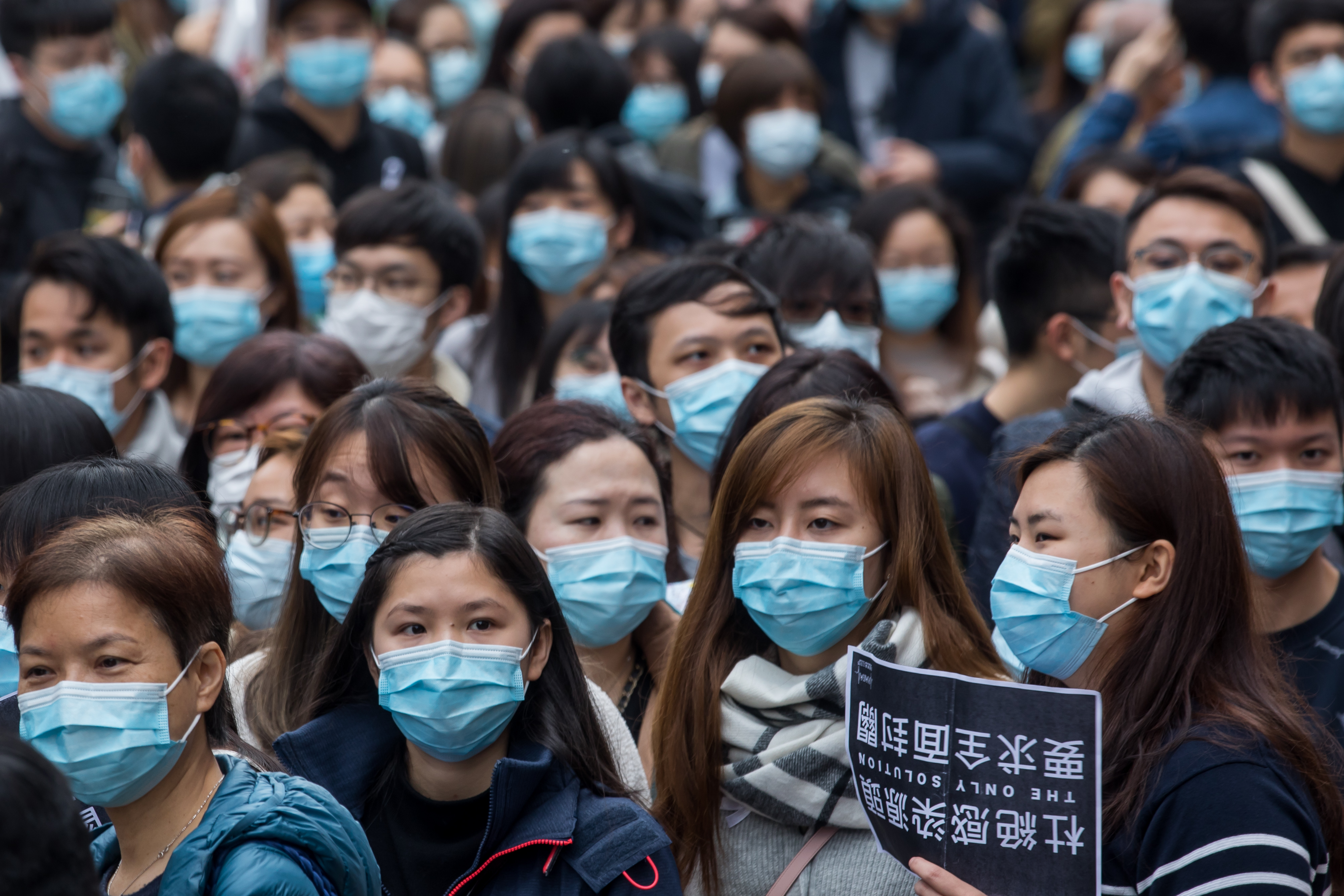 Medical workers wearing protective masks gather during a protest outside the Hospital Authority's head office in Hong Kong, China, on Feb. 4, 2020. (Paul Yeung/Bloomberg via Getty Images)