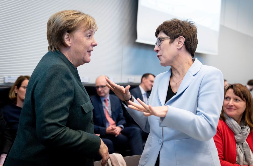 Chancellor Angela Merkel and Annegret Kramp-Karrenbauer (r, CDU), Federal Minister of Defence and CDU Federal Chairwoman, are talking at the beginning of the session of the CDU/CSU parliamentary group in the German Bundestag. Getty—Kay Nietfeld