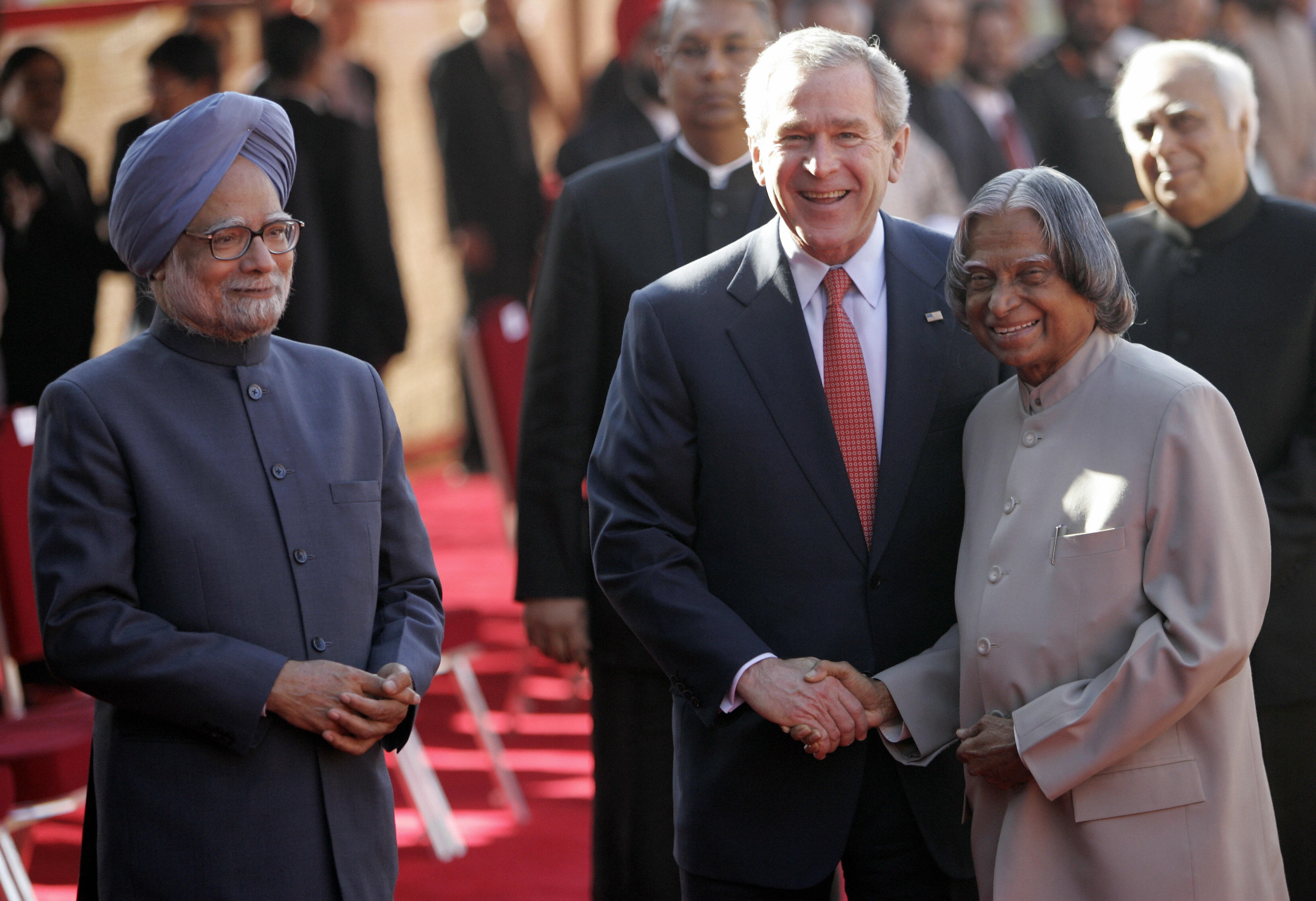 U.S. President George W. Bush shakes hands with Indian President A.P.J. Abdul Kalam while Prime Minister Manmohan Singh looks on during an official welcoming ceremony at the Presidential Palace in New Delhi on March 2, 2006. (Emmanuel Dunand–AFP/Getty Images)
