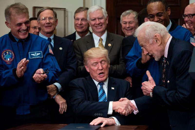 US President Donald Trump shakes Buzz Aldrin, former NASA Astronaut and second man on the moon, in the Roosevelt Room at the White House on June 30, 2017