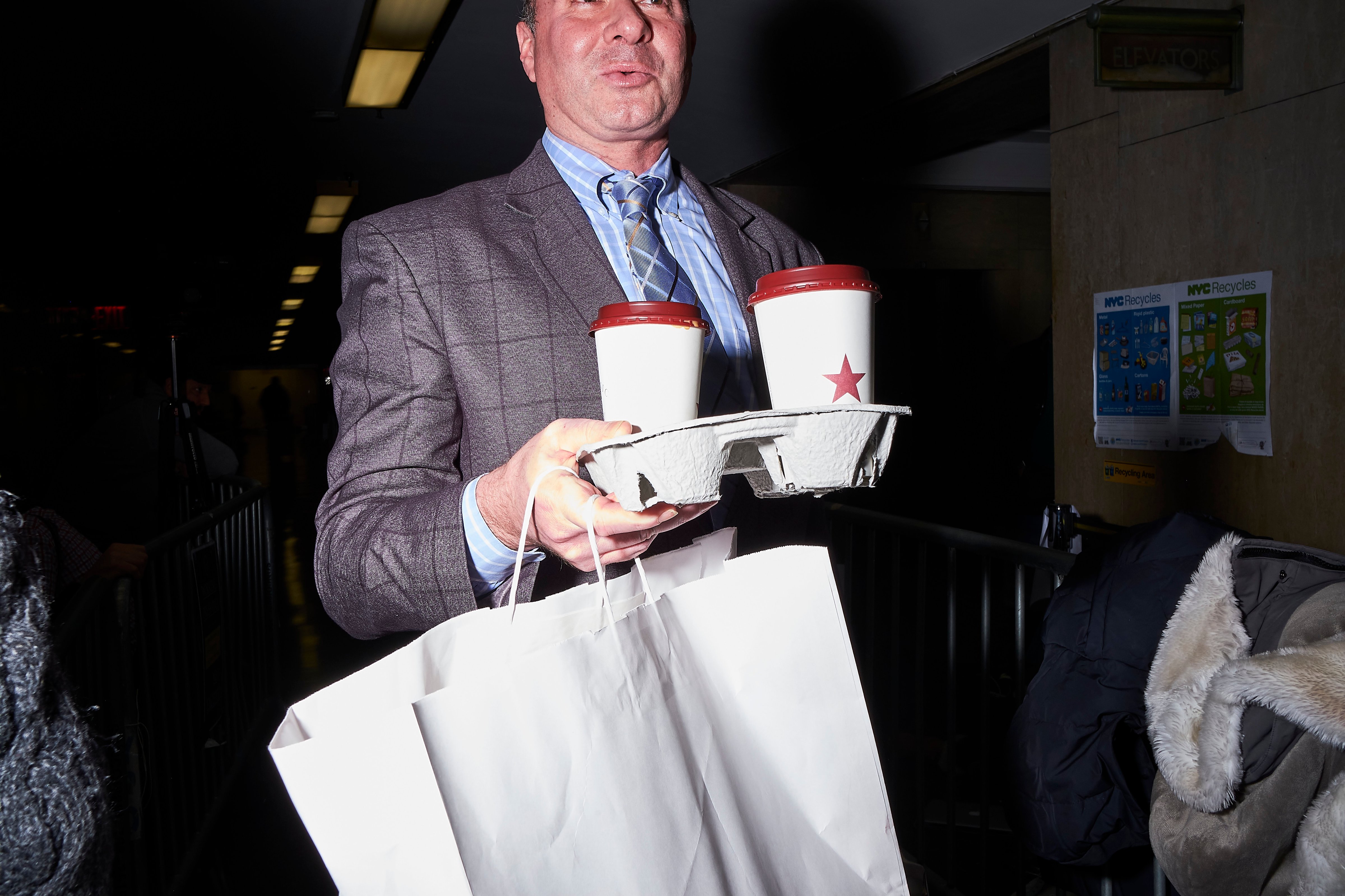 A member of Weinstein's legal team delivers lunch to his client in the courtroom on Jan. 22 (John Taggart)
