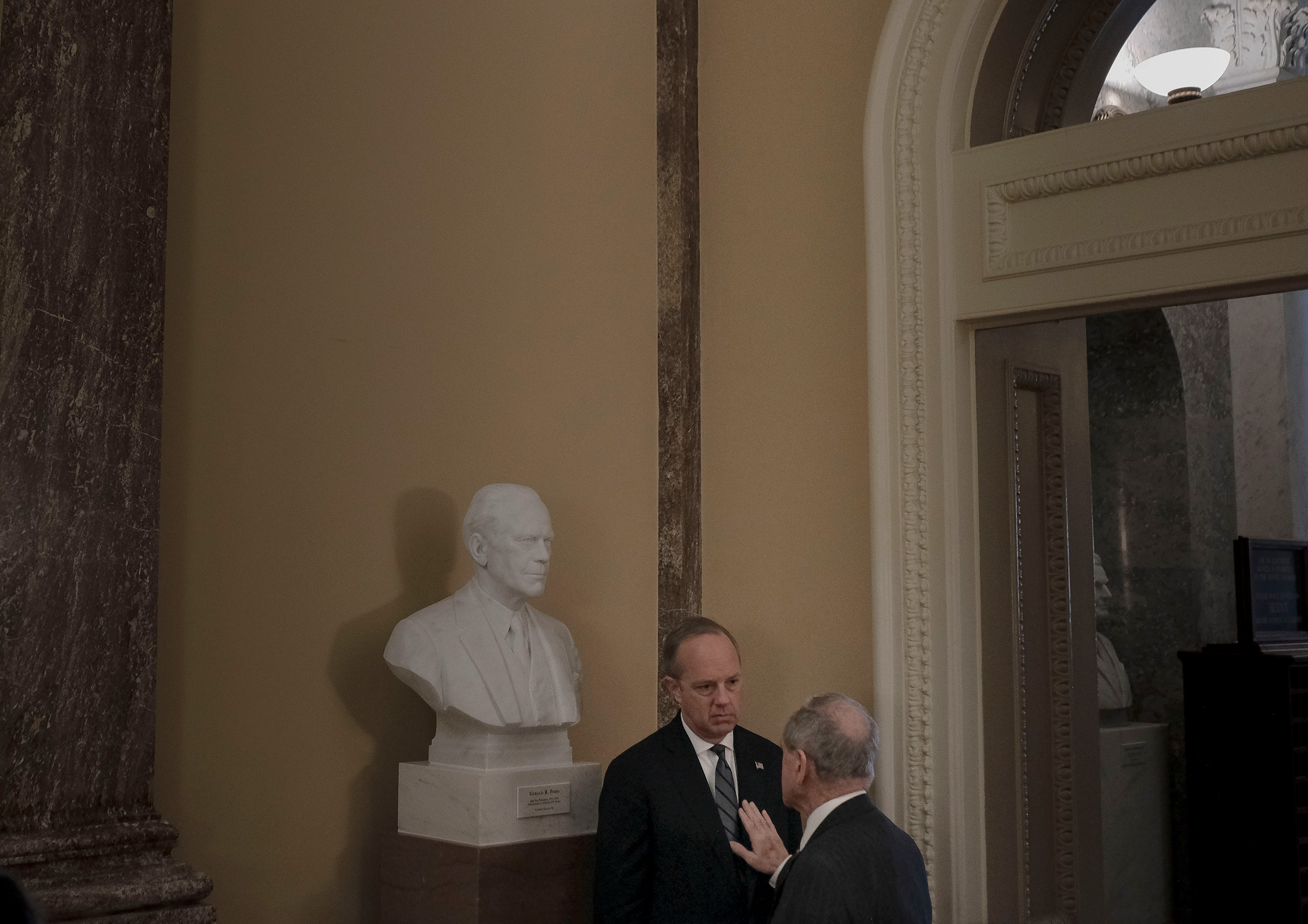 Sen. Jim Risch (R-Idaho) has a private conversation with White House legislative affairs director Eric Ueland off the floor of the senate before the impeachment trial at the Capitol in Washington, D.C., on Jan. 24, 2020. (Gabriella Demczuk for TIME)