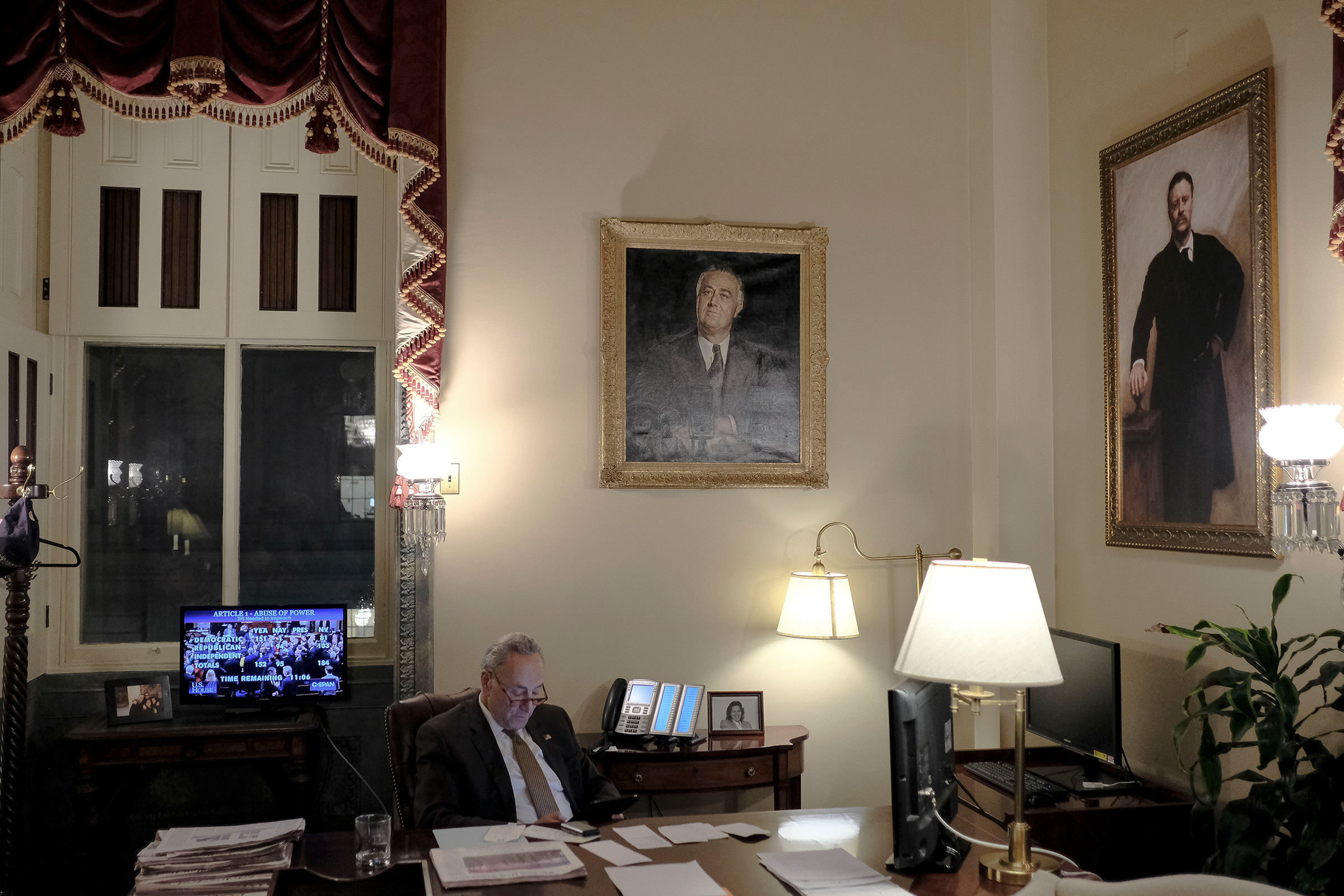 Senate Minority Leader Chuck Schumer (D-N.Y.) watches the House vote on the articles of impeachment in his office at the Capitol in Washington, D.C., on Dec. 18, 2019. (Gabriella Demczuk for TIME)