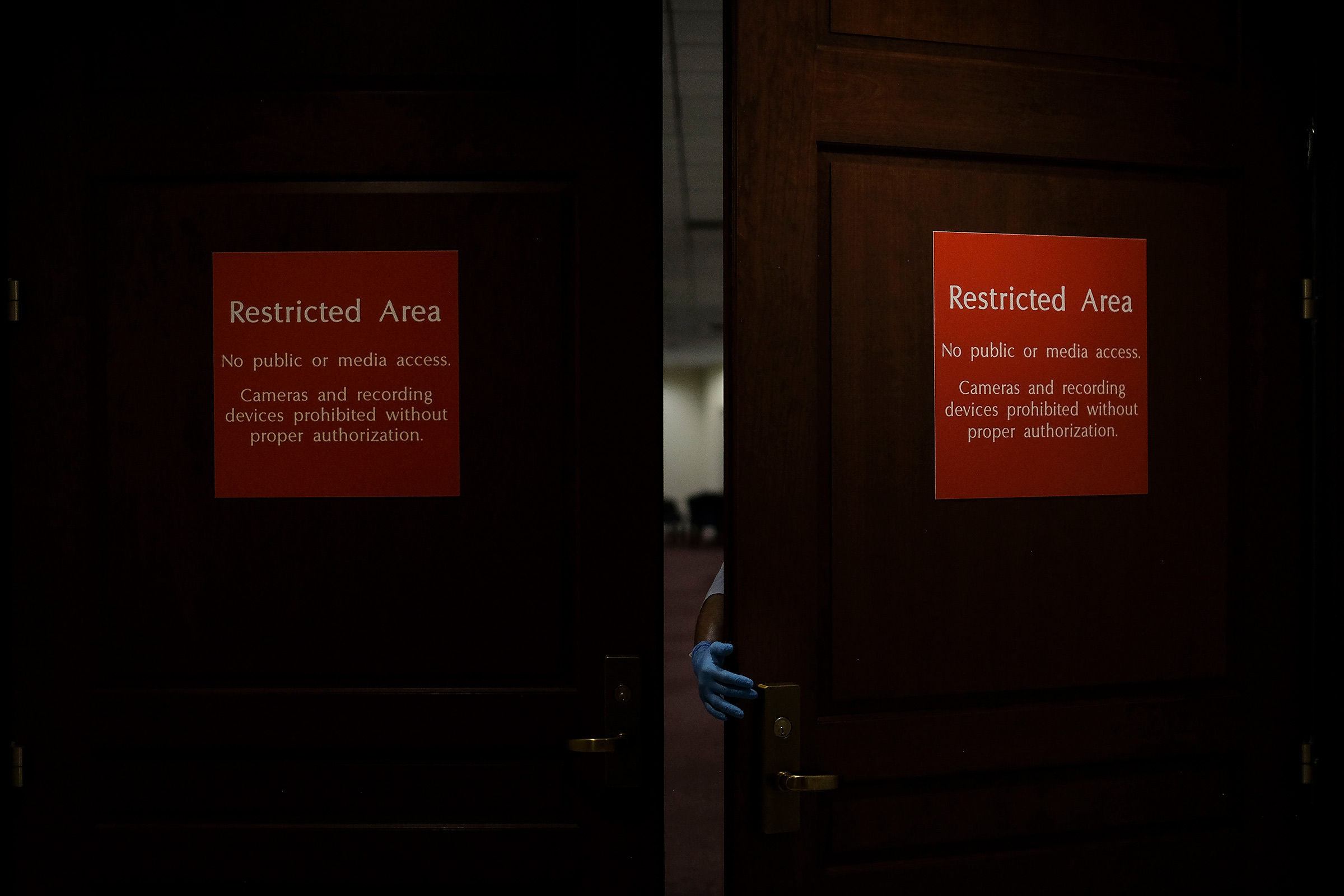 A custodial staff member walks into the sensitive compartmented information facility (SCIF), where Democrats conducted closed-door depositions during the House impeachment inquiry, in the basement of the Capitol in Washington, D.C., on Oct. 1, 2019. (Gabriella Demczuk for TIME)