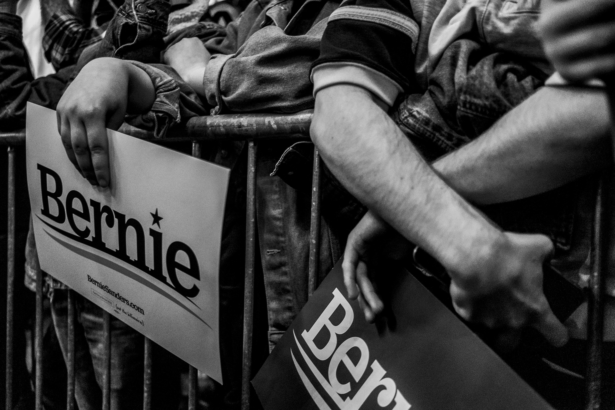 Supports of Sen. Bernie Sanders hold signs during the Bernie Caucus Concert