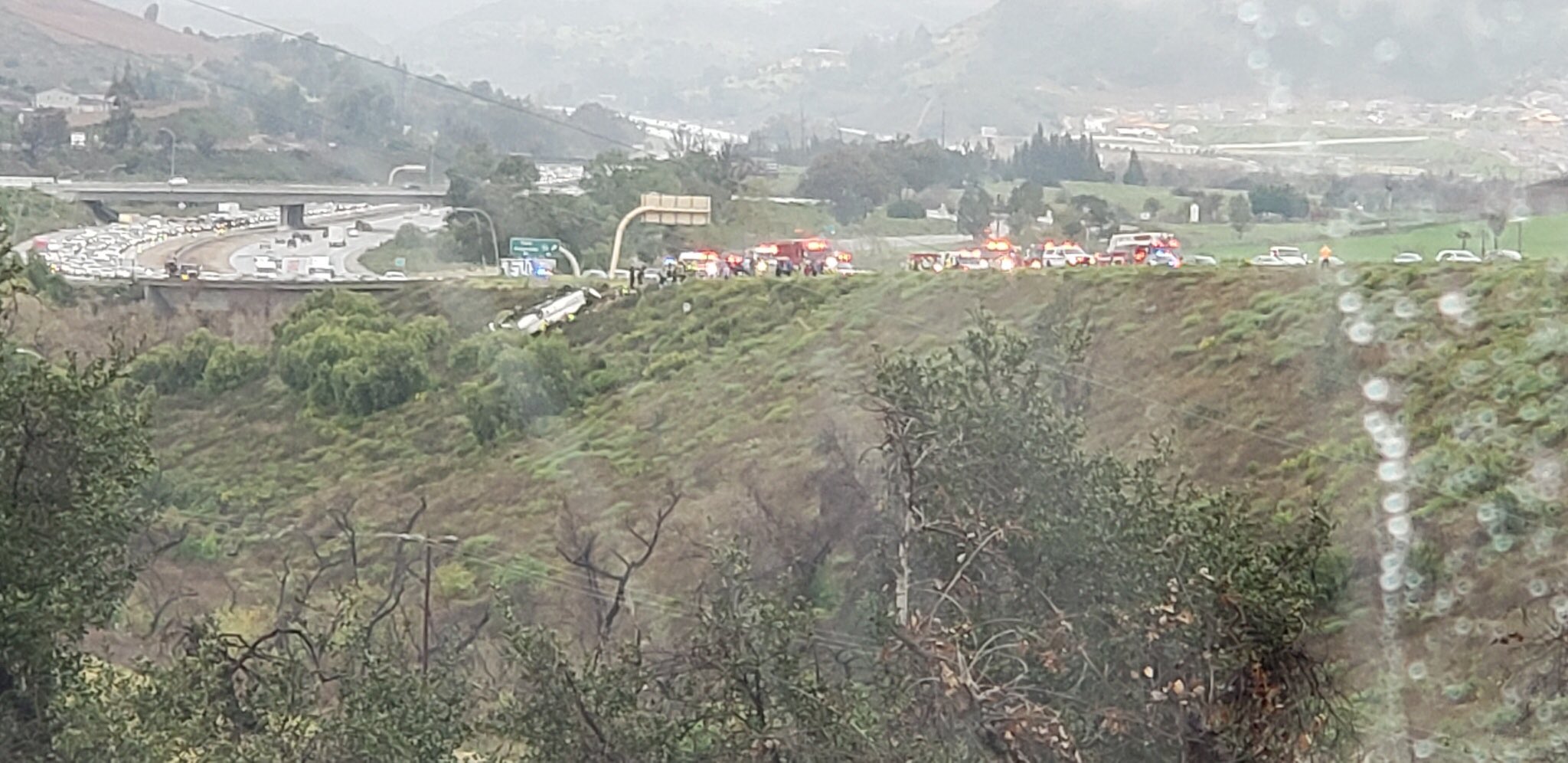A bus rolled over on the southbound side of I-15, trapping multiple people and killing at least 3, according to officials, in Fallbrook, Calif., on Feb. 22, 2020. (North County Fire Department)