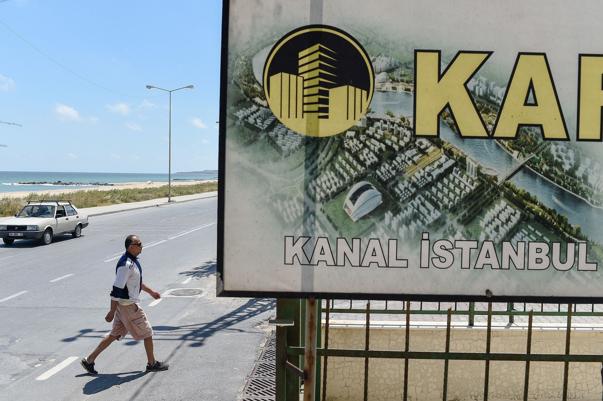 A real estate advertisement offers apartments with a view on the canal in the small coastal village of Karaburun, Turkey, in June 2018.