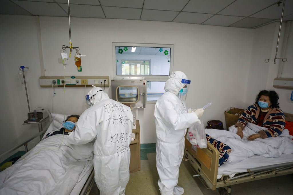 Two medical personnel work in the patients' ward in Jinyintan Hospital, designated for critical COVID-19 patients, in Wuhan in central China's Hubei province on Feb. 13, 2020. (Feature China/Barcroft Media/Getty Images)