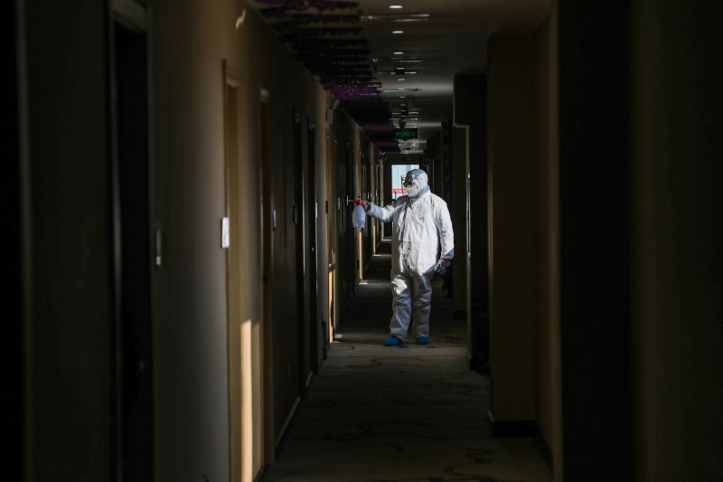 A medical worker disinfects a hotel converted into a quarantine zone in Wuhan, on Feb. 3