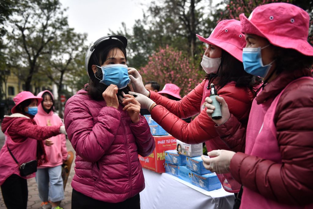 Volunteers hand out face masks in Hanoi, Vietnam.