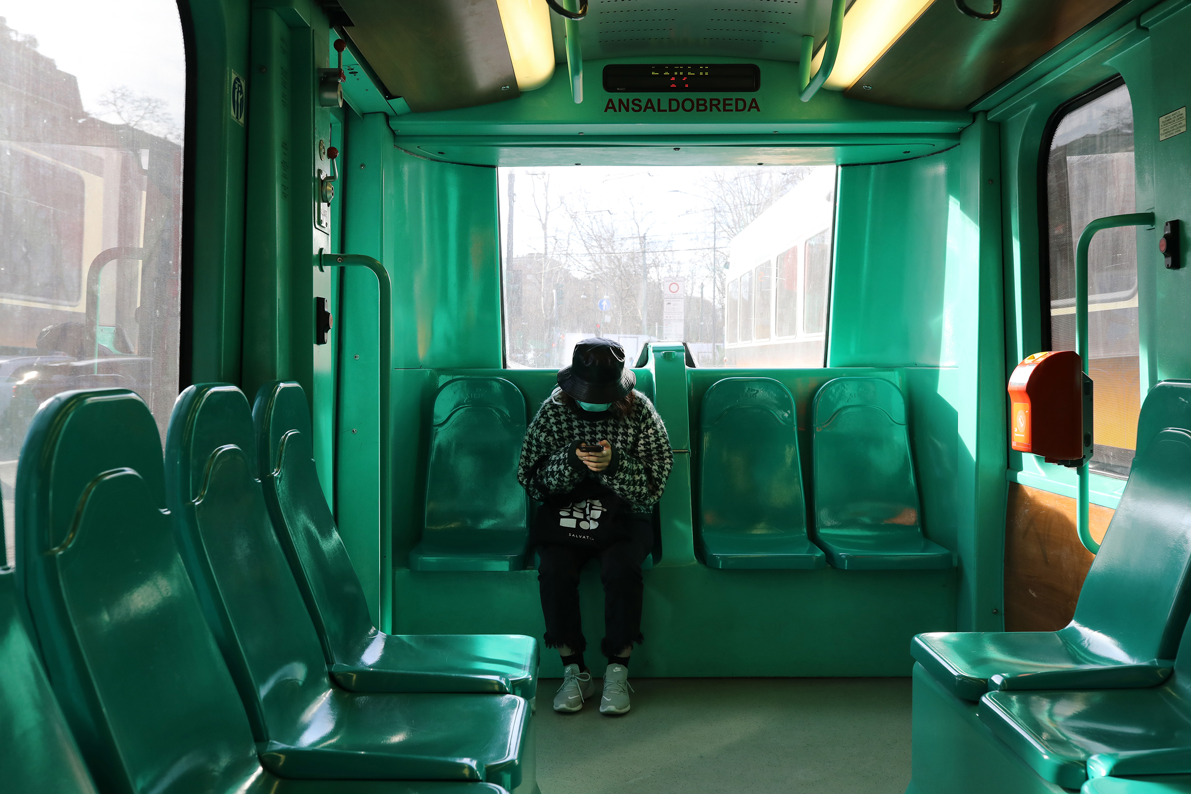 A woman wearing a protective mask is seen taking public transportation on Feb. 27 in Milan, Italy. (Marco Di Lauro—Getty Images)