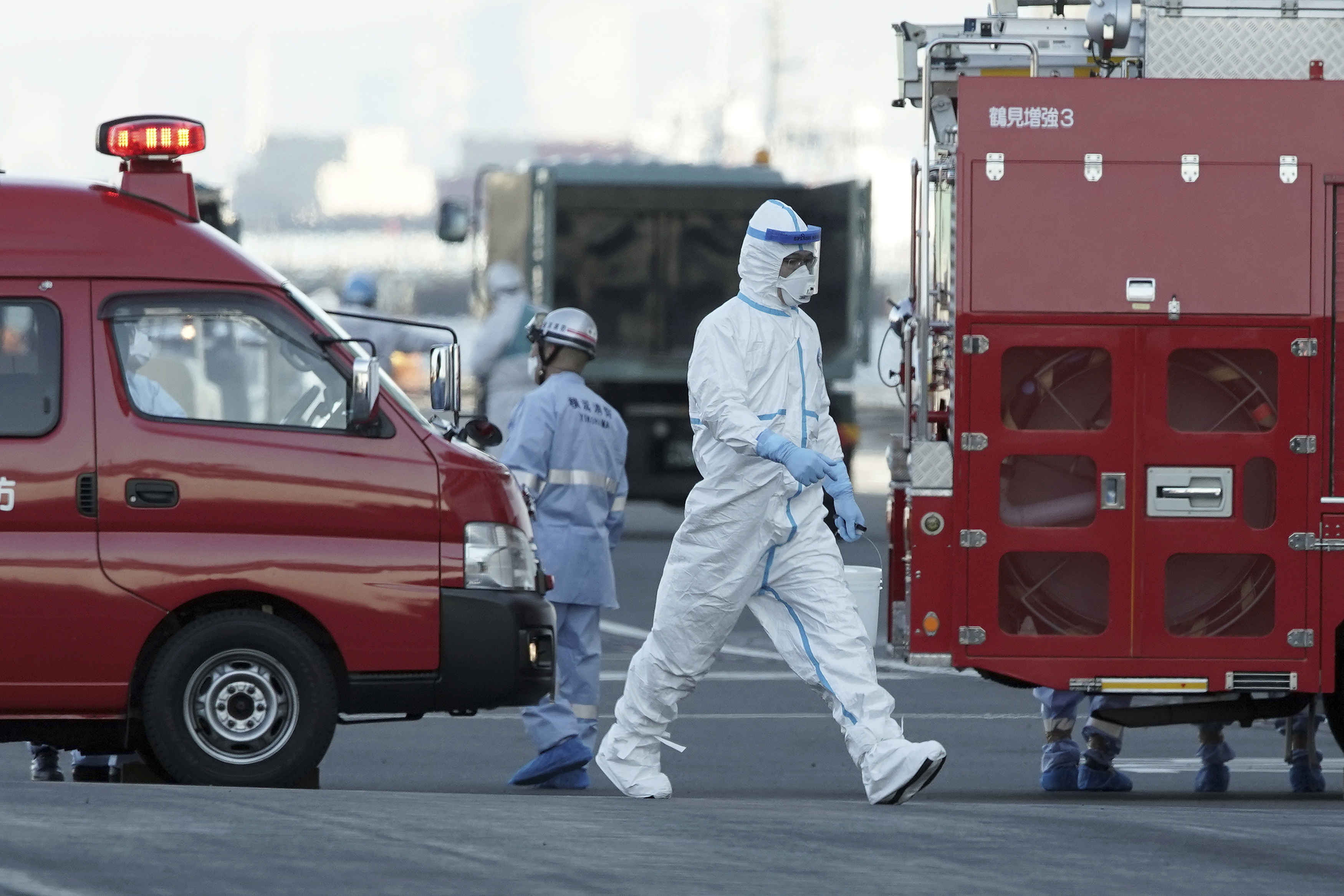 An official in a protective suit walks near the Diamond Princess docked in Yokohama, Tokyo, on Feb. 10, 2020. (AP—Copyright 2020 The Associated Press. All rights reserved.)
