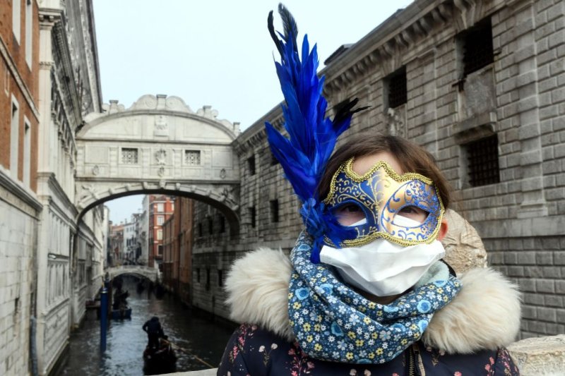 A young tourist joining in on carnival festivities wears a facemask in Venice, Italy, on Feb. 24, 2020.