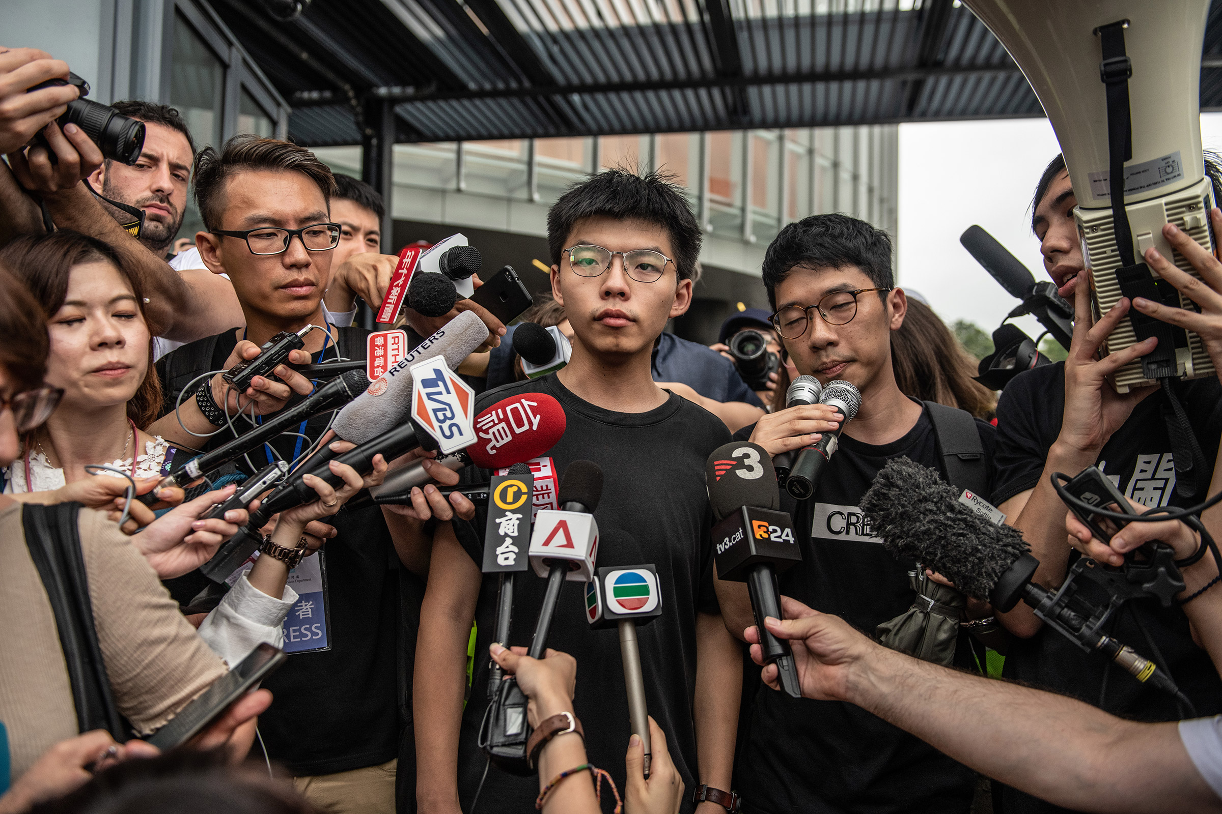 Pro-democracy activist Joshua Wong speaks to the media outside the Legislative Council shortly after being released from prison on June 17, 2019 in Hong Kong. (Carl Court—Getty Images)