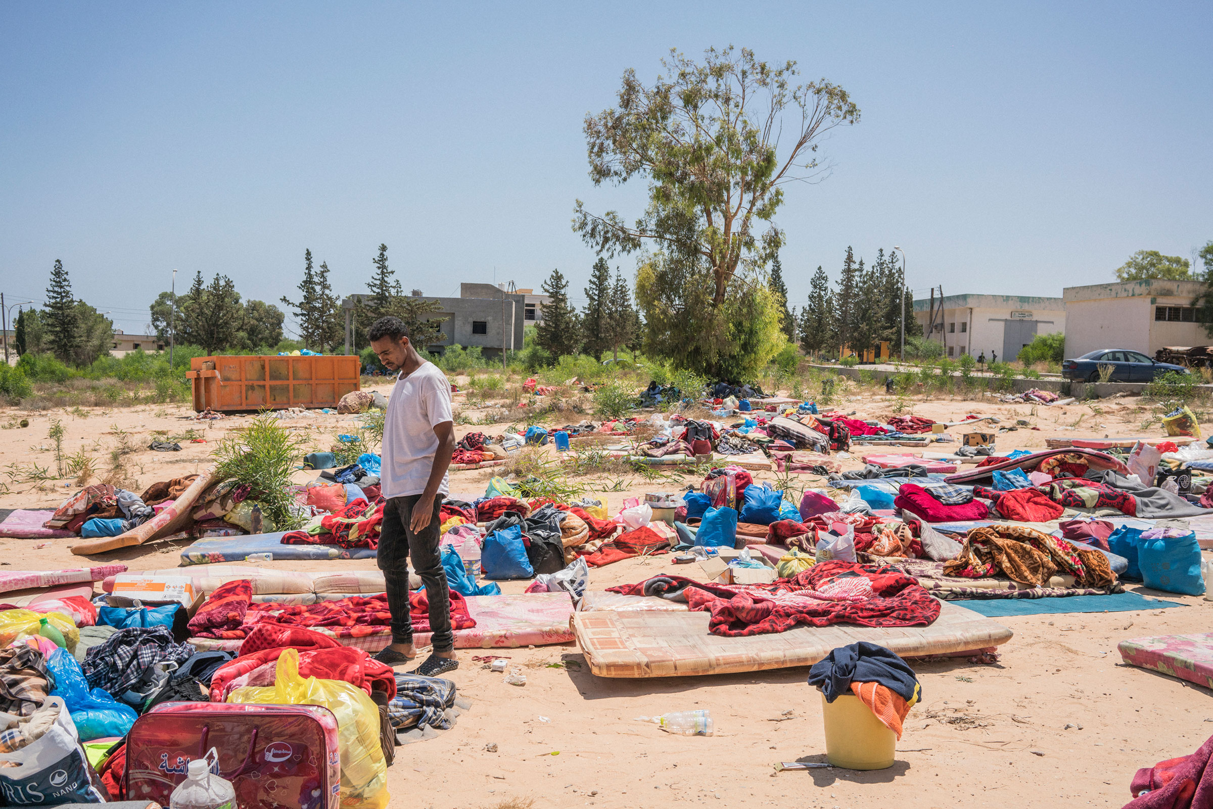 A man stands near damaged belongings after an airstrike hit a detention center, killing 53 people and injuring about 130 people, near Tripoli on July 3, 2019. (Emanuele Satolli)
