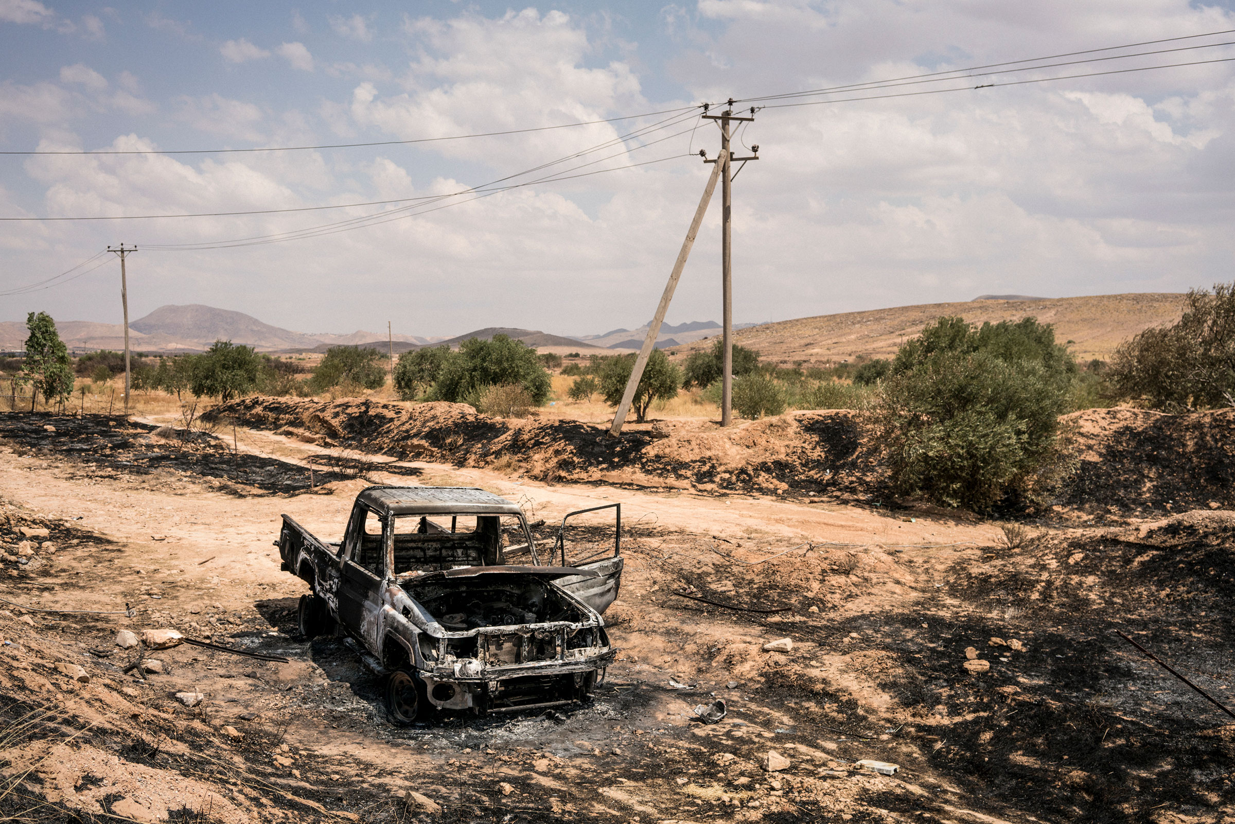 A vehicle burned during fighting in northwestern Gharyan on June 28, 2019. (Emanuele Satolli)