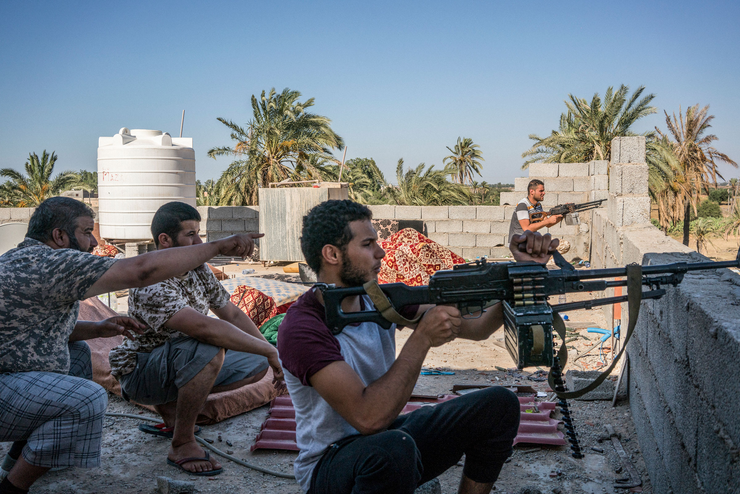 Fighters loyal to the Government of National Accord (GNA) spot positions of fighters loyal to Haftar on the international airport front line in Tripoli on July 4, 2019. (Emanuele Satolli)