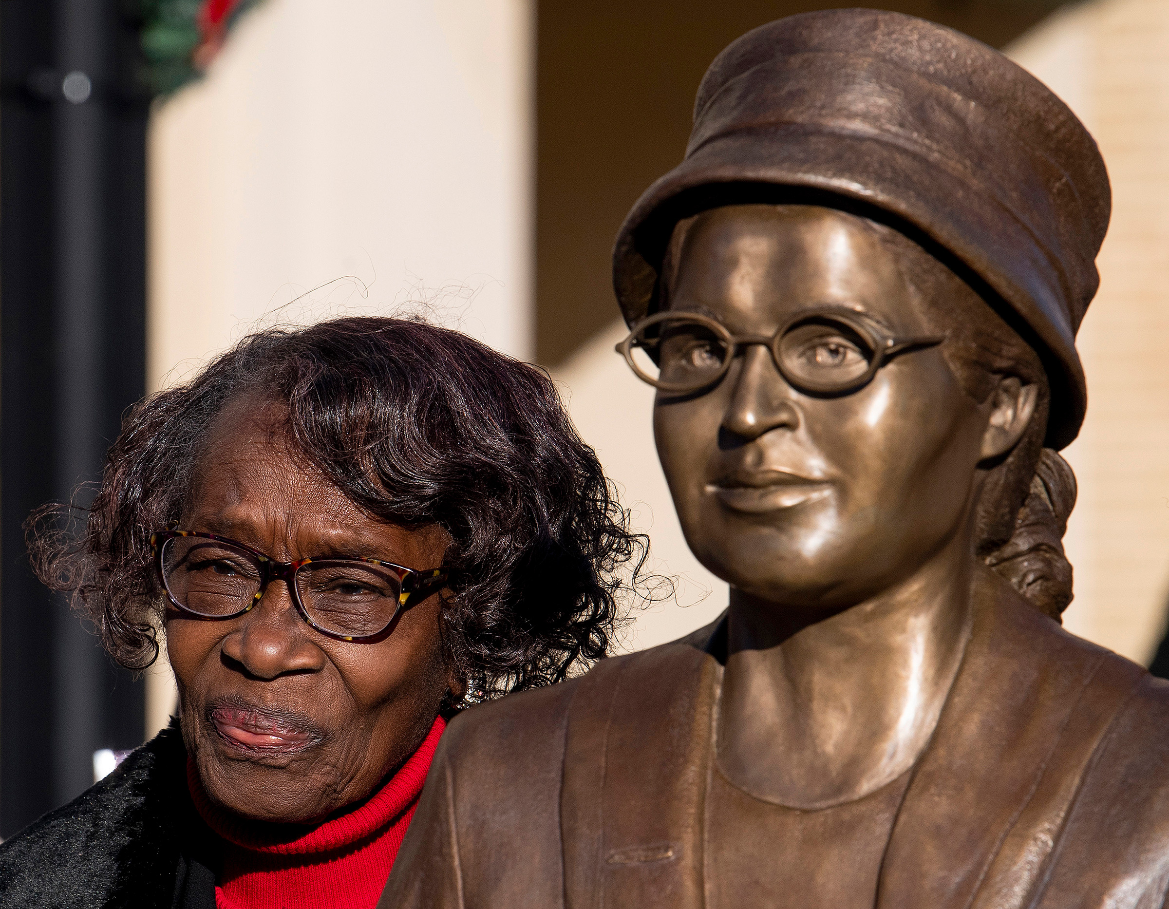 Mary Louise Smith, a plaintiff in the Browder vs. Gayle case that desegregated buses in Montgomery, stands beside the Rosa Parks statue after its unveiling event in downtown Montgomery, Ala., on Dec. 1, 2019, the anniversary of her arrest for not giving up her seat on a city bus.