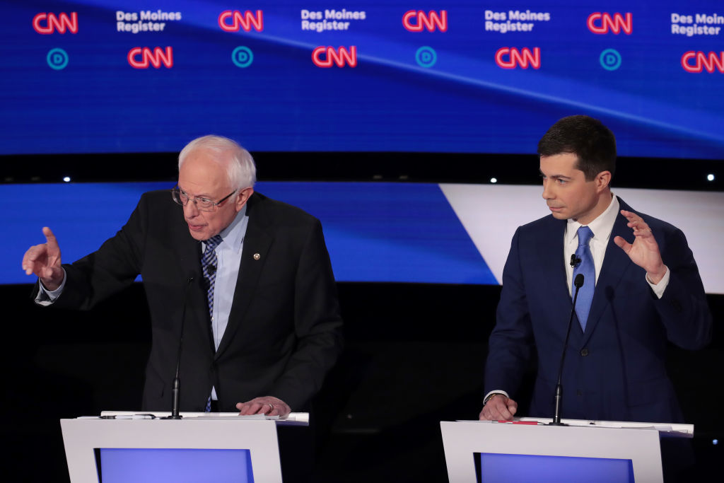 Former South Bend, Indiana Mayor Pete Buttigieg listens as Sen. Bernie Sanders (I-VT) makes a point during the Democratic presidential primary debate at Drake University on January 14, 2020 in Des Moines, Iowa. (Scott Olson—Getty Images)