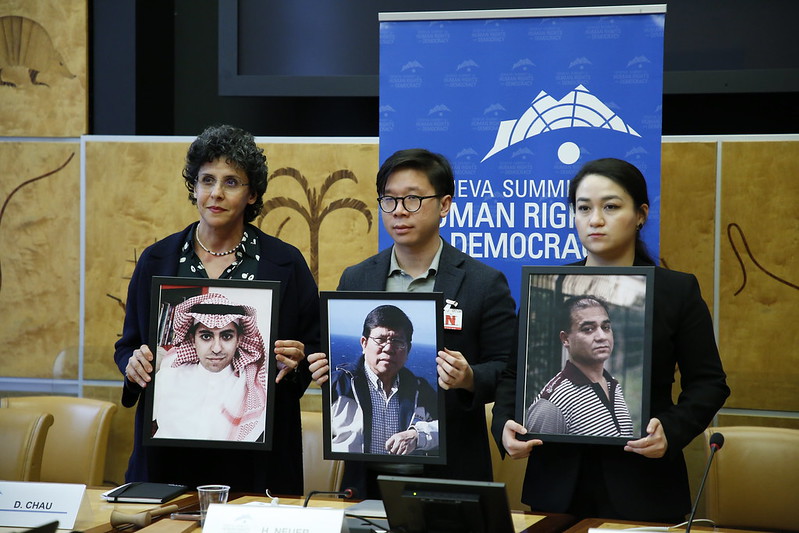 Ellham Manea (L) holds a photo of political prisoner Raif Badawi. (Oliver O'Hanlon/Courtesy of U.N. Watch)