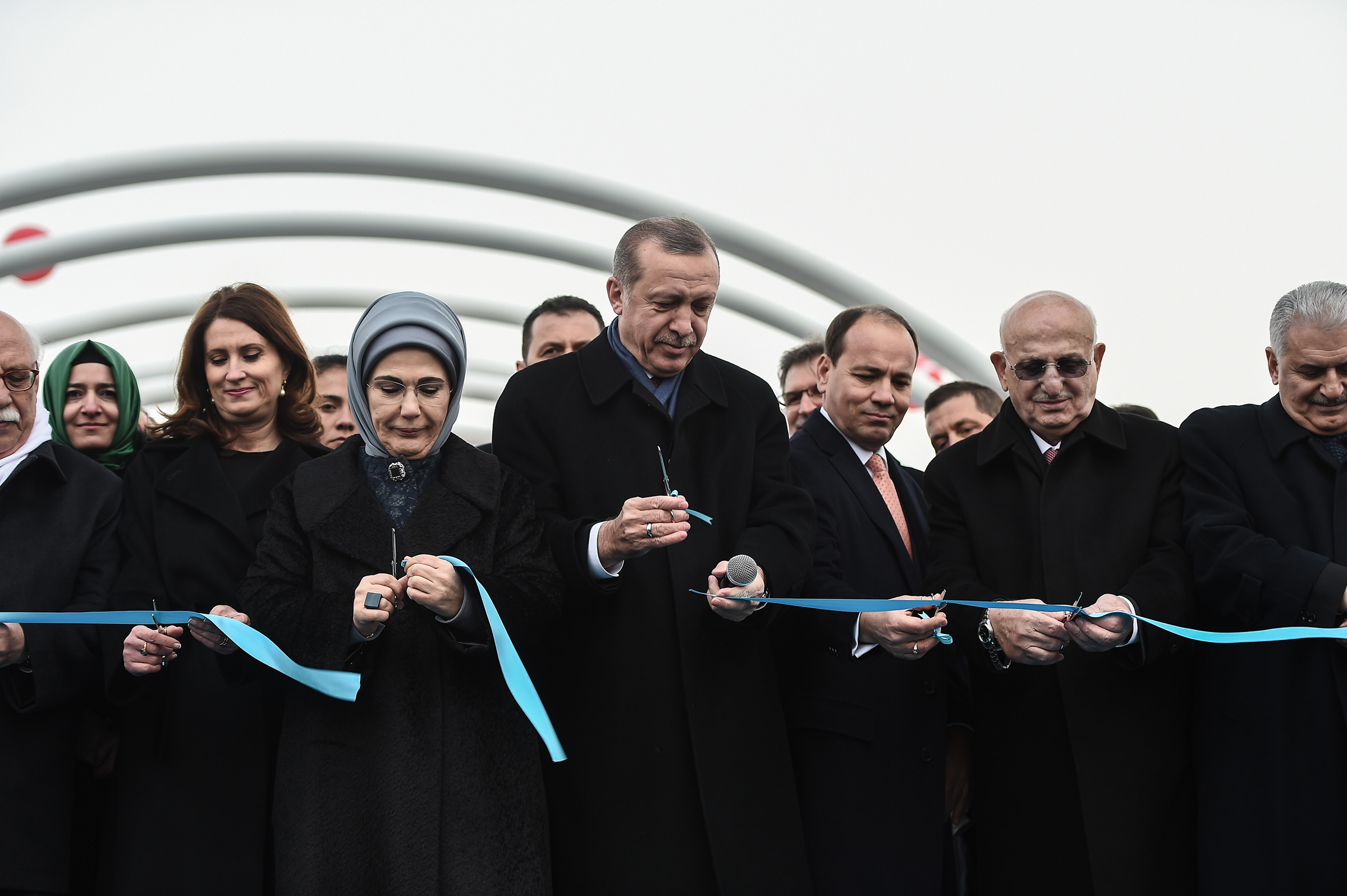 Turkish President Recep Tayyip Erdogan, center, with his wife Emine Erdogan by his side and Prime Minister Binali Yildirim, right, during the opening ceremony of a road tunnel underneath the Bosporus Strait in Istanbul in December 2016.