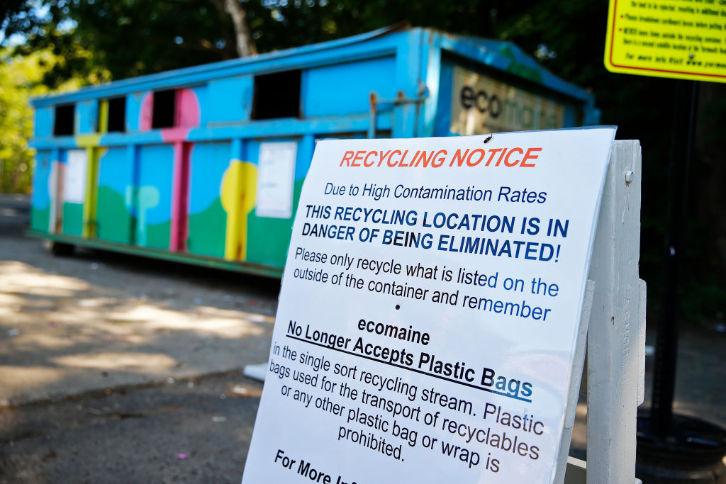 A sign posted by Ecomaine in Yarmouth warns residents that the program could be eliminated. (Ben McCanna/Portland Portland Press Herald via Getty Images)