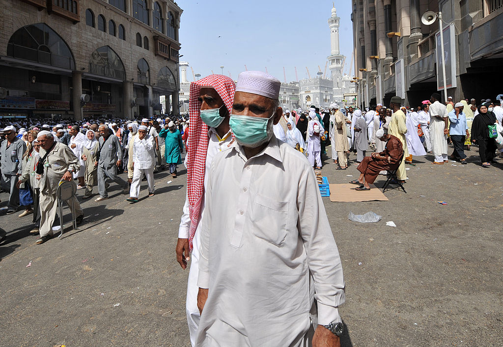 Muslim pilgrims wearing a mask leave after the Friday prayer at Mecca's Grand Mosque, on Oct. 11, 2013 as hundreds of thousands of Muslims have poured into the holy city of Mecca for the annual hajj pilgrimage. (Fayez Nureldine–AFP/Getty Images)