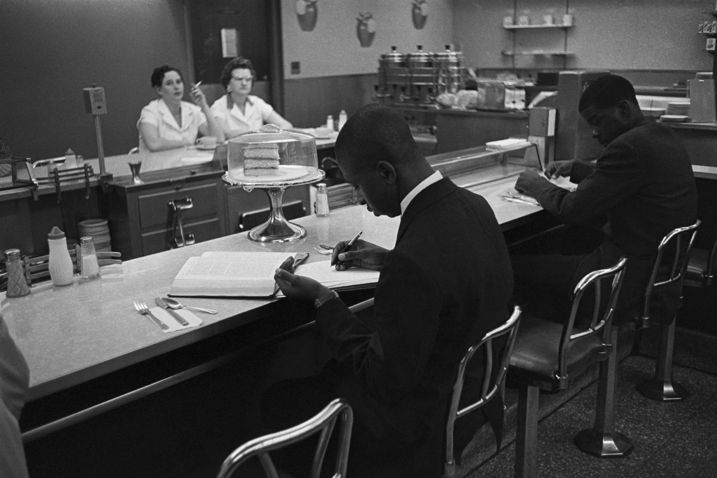 African-American students from Saint Augustine College study while participating in a sit-in at a lunch counter reserved for white customers in Raleigh, N.C. (Bettmann Archive/Getty Images)