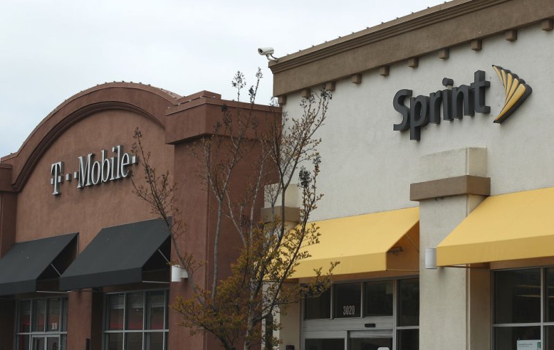 A T-Mobile and Sprint store sit side-by-side in a strip mall on April 30, 2018 in El Cerrito, California.