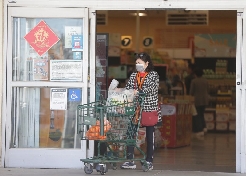 A customer wears a face mask as she shops at the 168 Market in Alhambra, Calif., on Jan. 31, 2020.