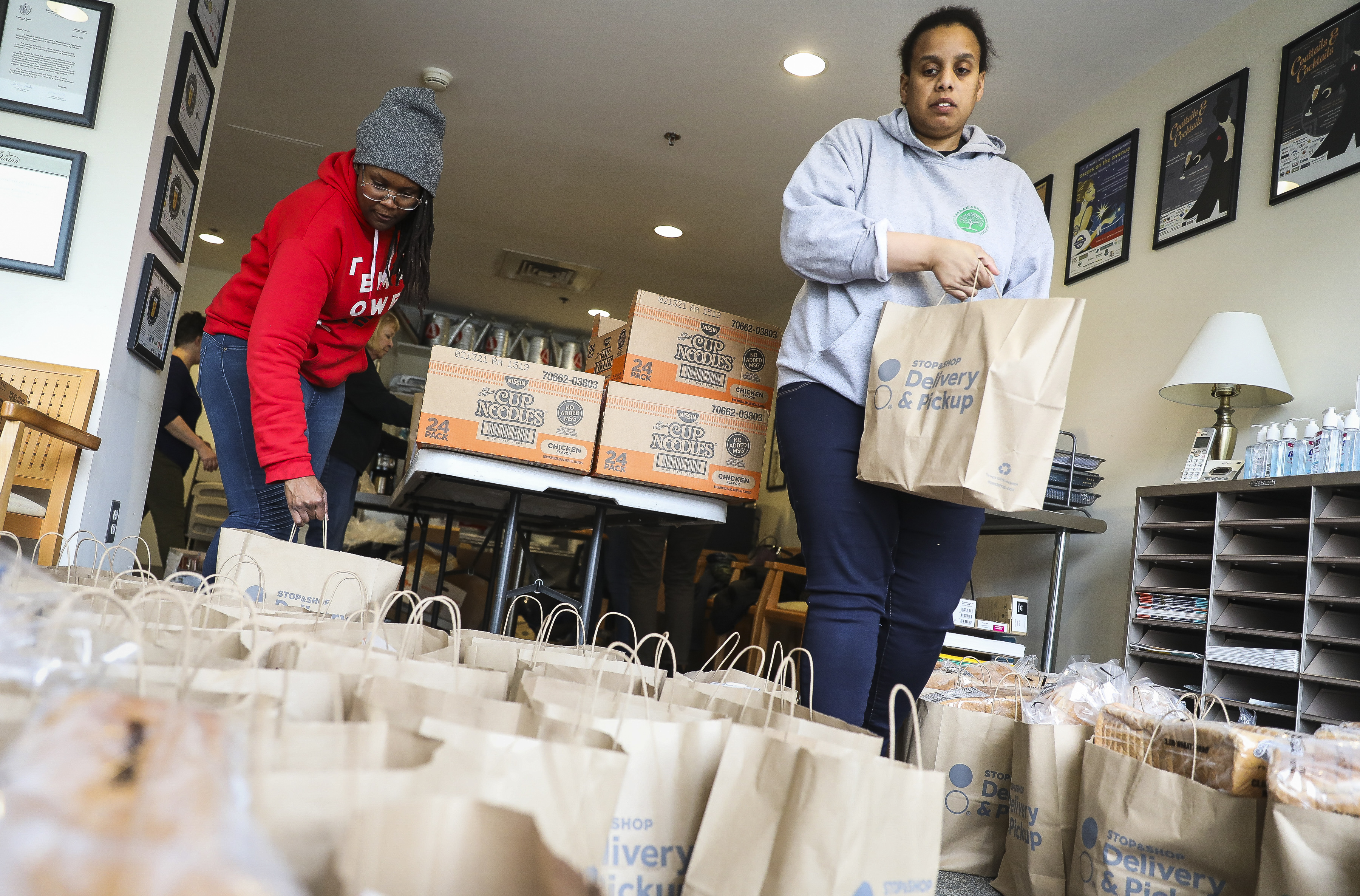 Joy Gary, left, and Yvonne Pope help bag donated food for students and families who may need it if the Boston Public Schools shut down, on March 11, 2020. (Erin Clark—Boston Globe/Getty Images)