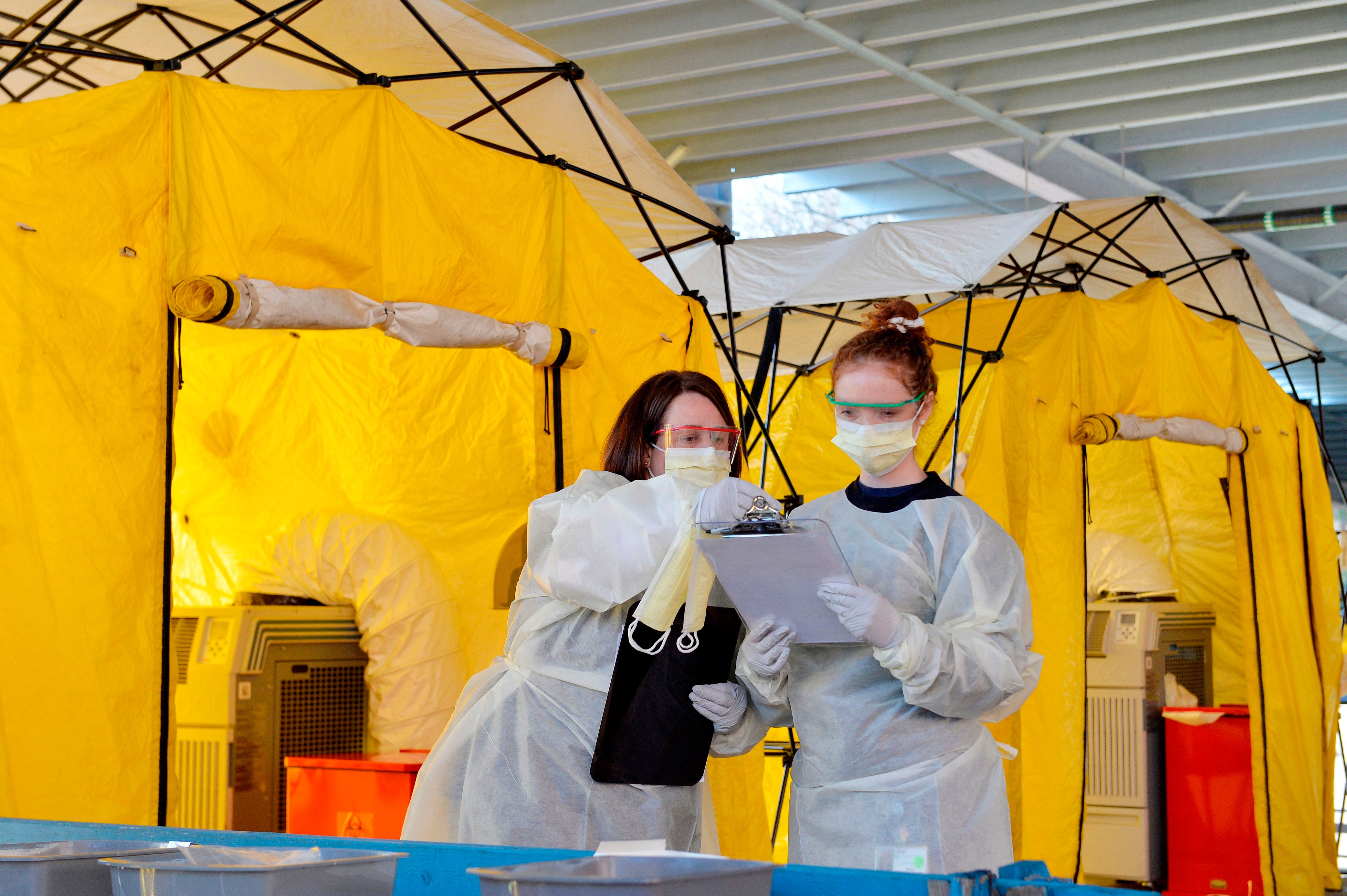 Hospital clinicians work to test patients for the coronavirus, Covid-19 at Newton-Wellesley Hospital in Newton, Massachusetts on March 18, 2020, as the hospital has set up three tents in the parking garage where patients who have been pre-screened can show up for testing. (Joseph Prezioso—AFP/Getty Images)
