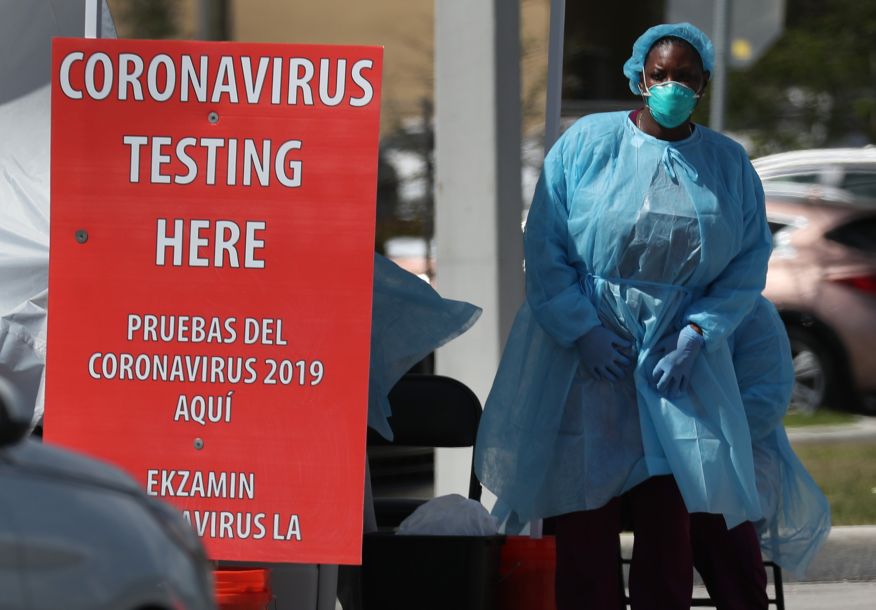 A member of the health care staff from the Community Health of South Florida, Inc. (CHI) prepares to test people for the coronavirus in the parking lot of its Doris Ison Health Center on March 18 in Miami, Florida. (Joe Raedle—Getty Images)