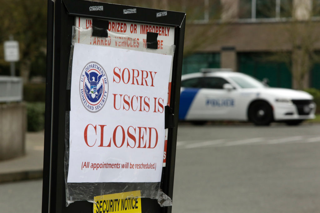 A sign indicating the office is closed is posted following a two-week closure of a Department of Homeland Security (DHS) building and US Citizenship and Immigration Services (USCIS) field office because of an employee who may be infected with the novel coronavirus in Tukwila, Washington on March 3, 2020. (Jason Redmond / AFP via Getty Images)
