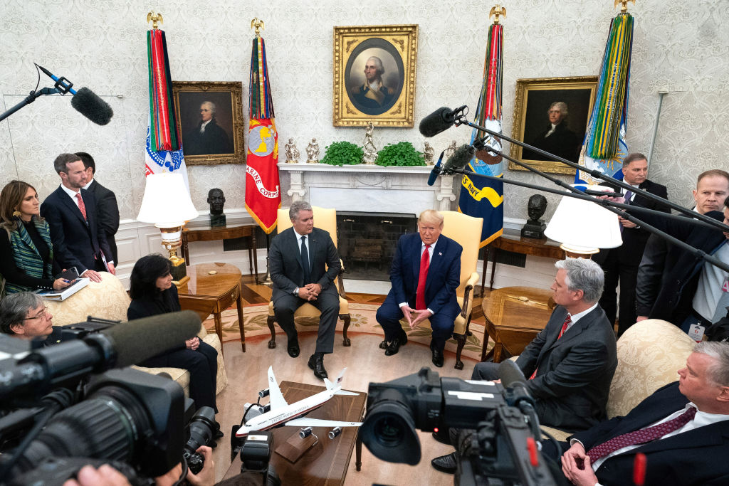 U.S. President Donald Trump speaks while Ivan Duque, Colombia's president, center left, listens during a meeting in the Oval Office of the White House in Washington, D.C., on March 2, 2020. (Kevin Dietsch—UPI/Bloomberg/Getty Images)