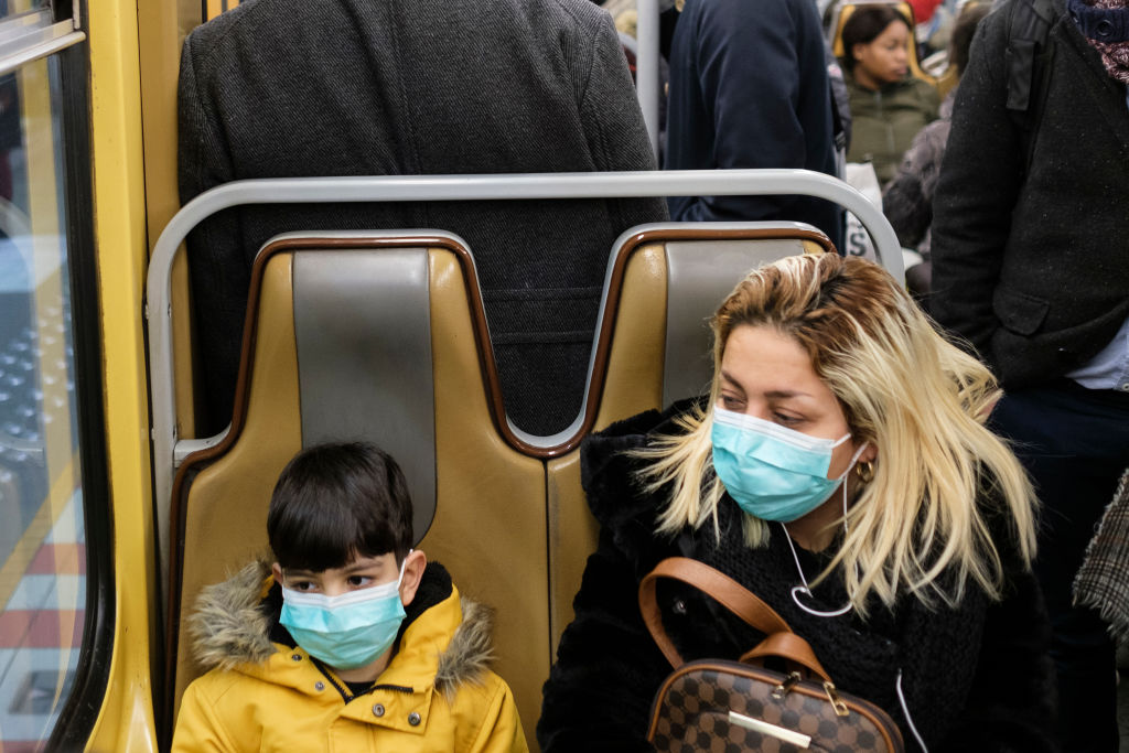 People wearing face masks on a train system in Brussels, Belgium, on March 3, 2020. (Thierry Monasse/Getty Images)