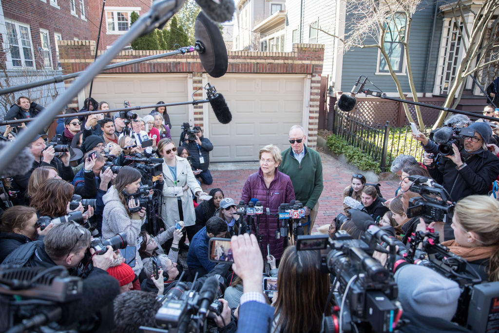 Democratic presidential candidate Sen. Elizabeth Warren (D-MA), with husband Bruce Mann, announces that she is dropping out of the presidential race during a media availability outside of her home in Cambridge, MA, on March 5, 2020. (Scott Eisen—Getty Images)