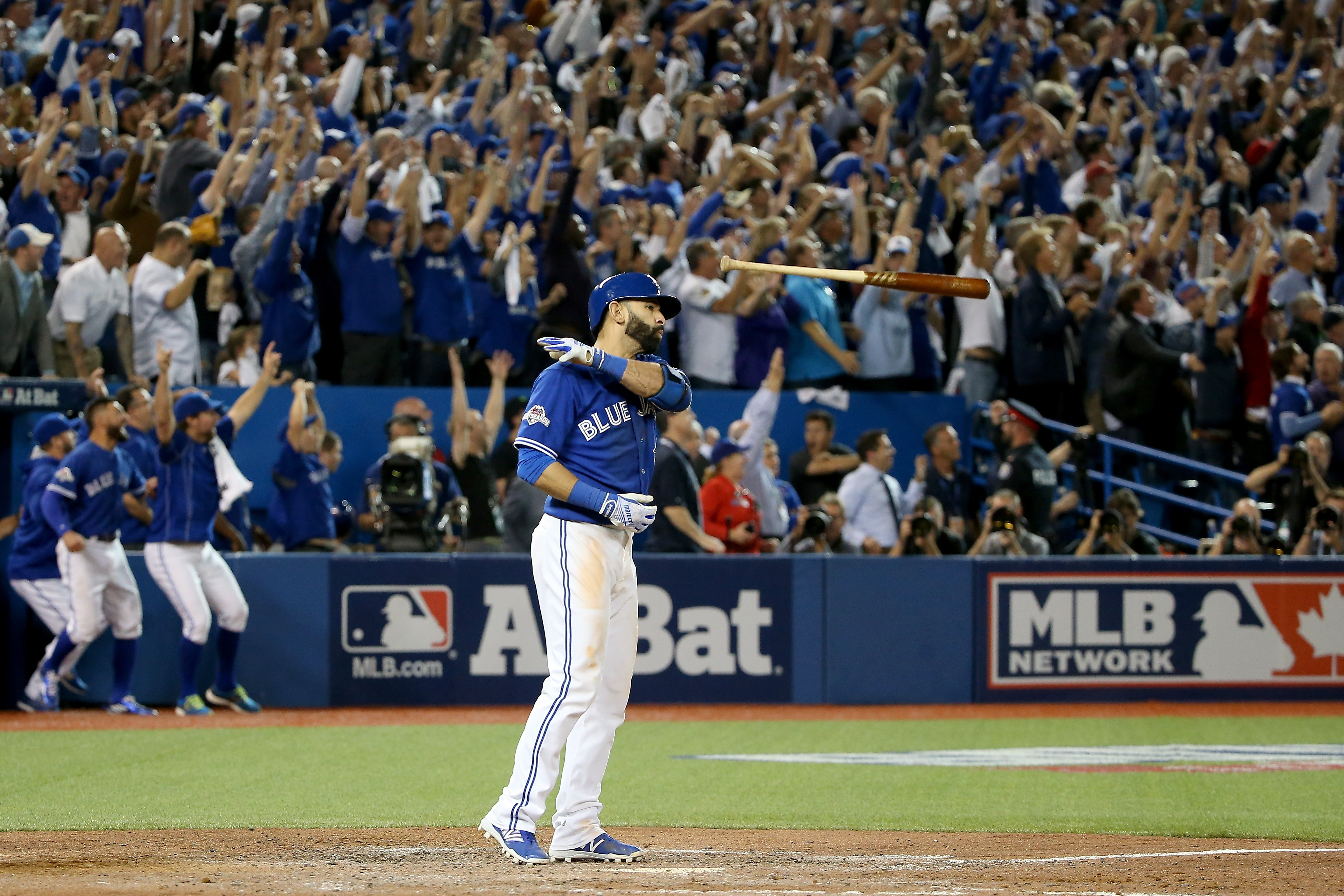 Jose Bautista of the Toronto Blue Jays flips his bat up in the air after he hits a three-run home run in the seventh inning against the Texas Rangers in game five of the American League Division Series at Rogers Centre on October 14, 2015 in Toronto, Canada. (Getty Images—2015 Getty Images)