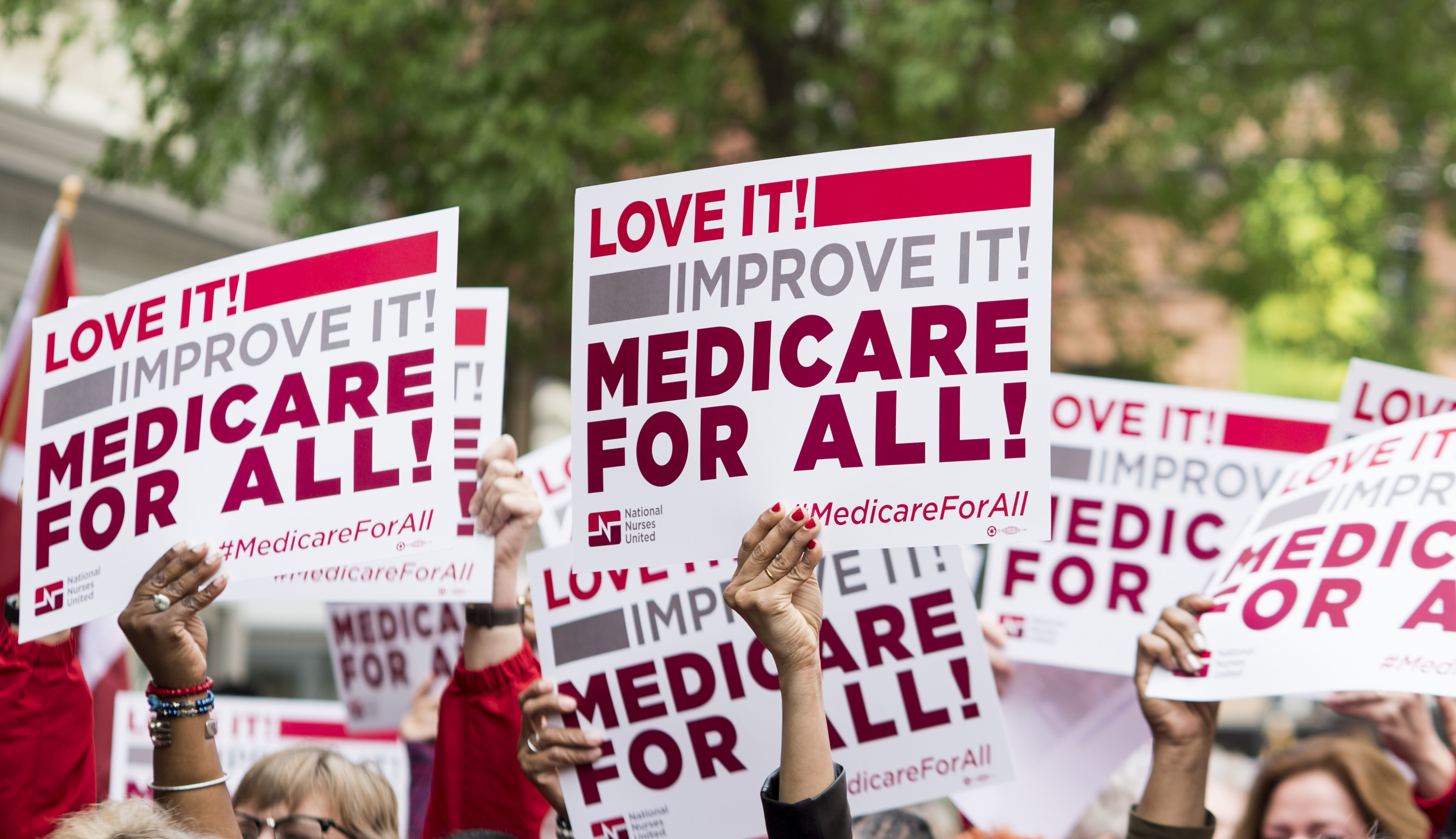 Members of National Nurses United union members wave "Medicare for All" signs during  a rally in front of the Pharmaceutical Research and Manufacturers of America in Washington calling for "Medicare for All" on Monday, April 29, 2019. (Bill Clark—CQ-Roll Call/Getty Images)