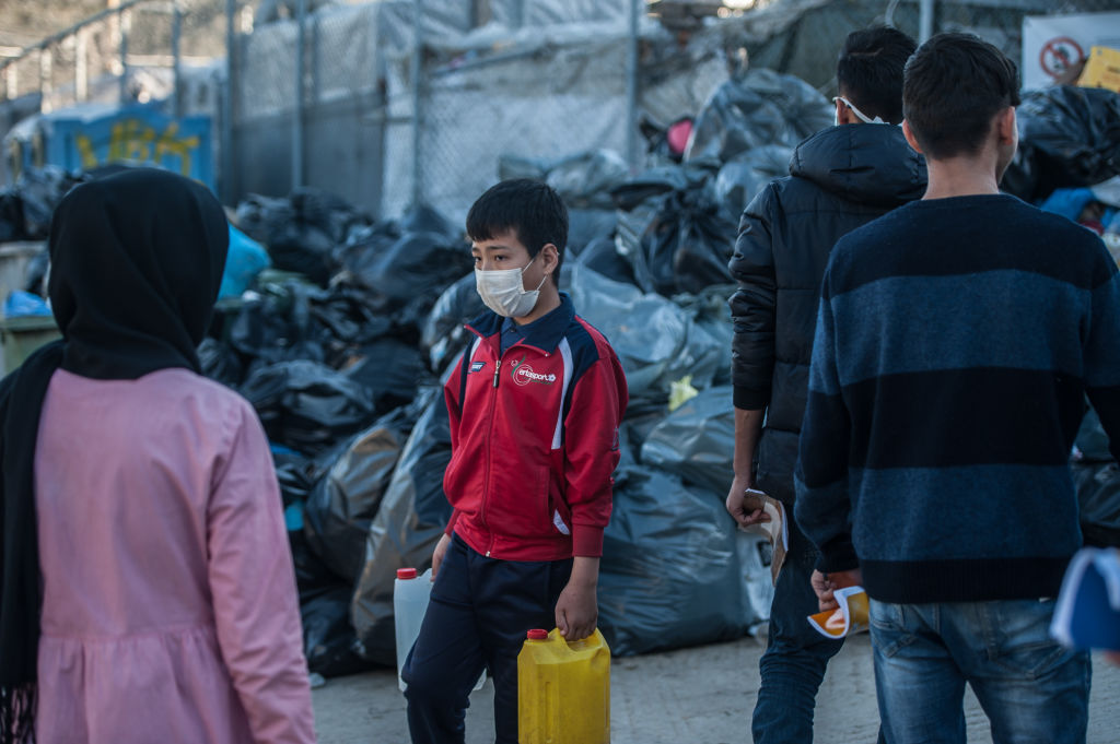 Camp residents wear surgical masks to protect from coronavirus on March 12, 2020 in Mytilene, Greece. (Guy Smallman—Getty Images)