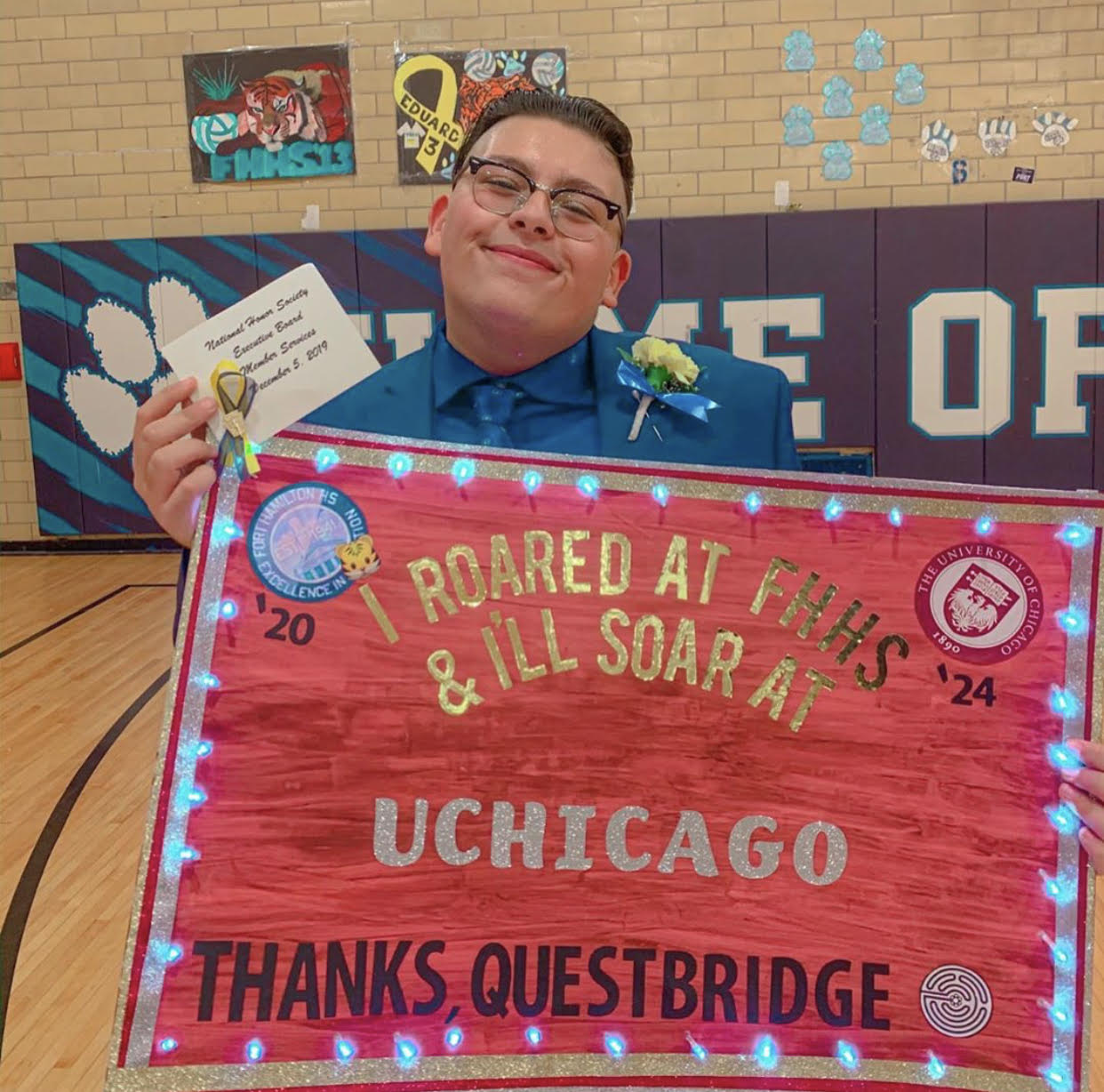 17-year-old Youssef Hasweh holds up a thank-you poster he made for Questbridge, which matches low-income students to scholarships at top colleges. Hasweh applied to the University of Chicago through the non-profit and will begin classes at the school in the fall. (Courtesy Youssef Hasweh)