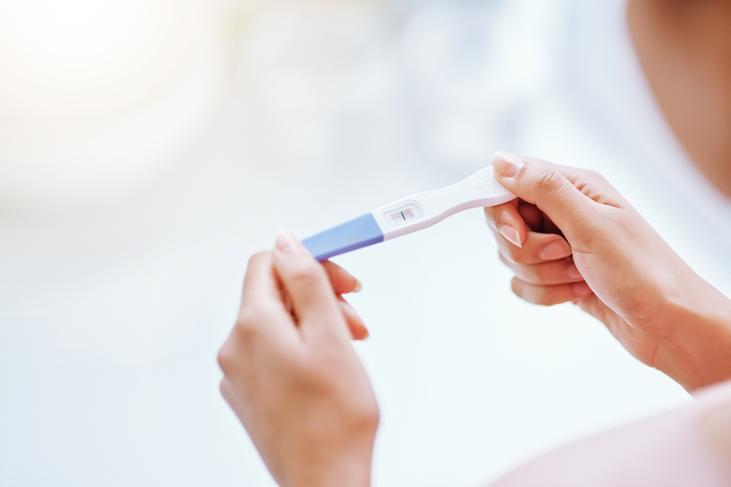 A young woman taking a pregnancy test